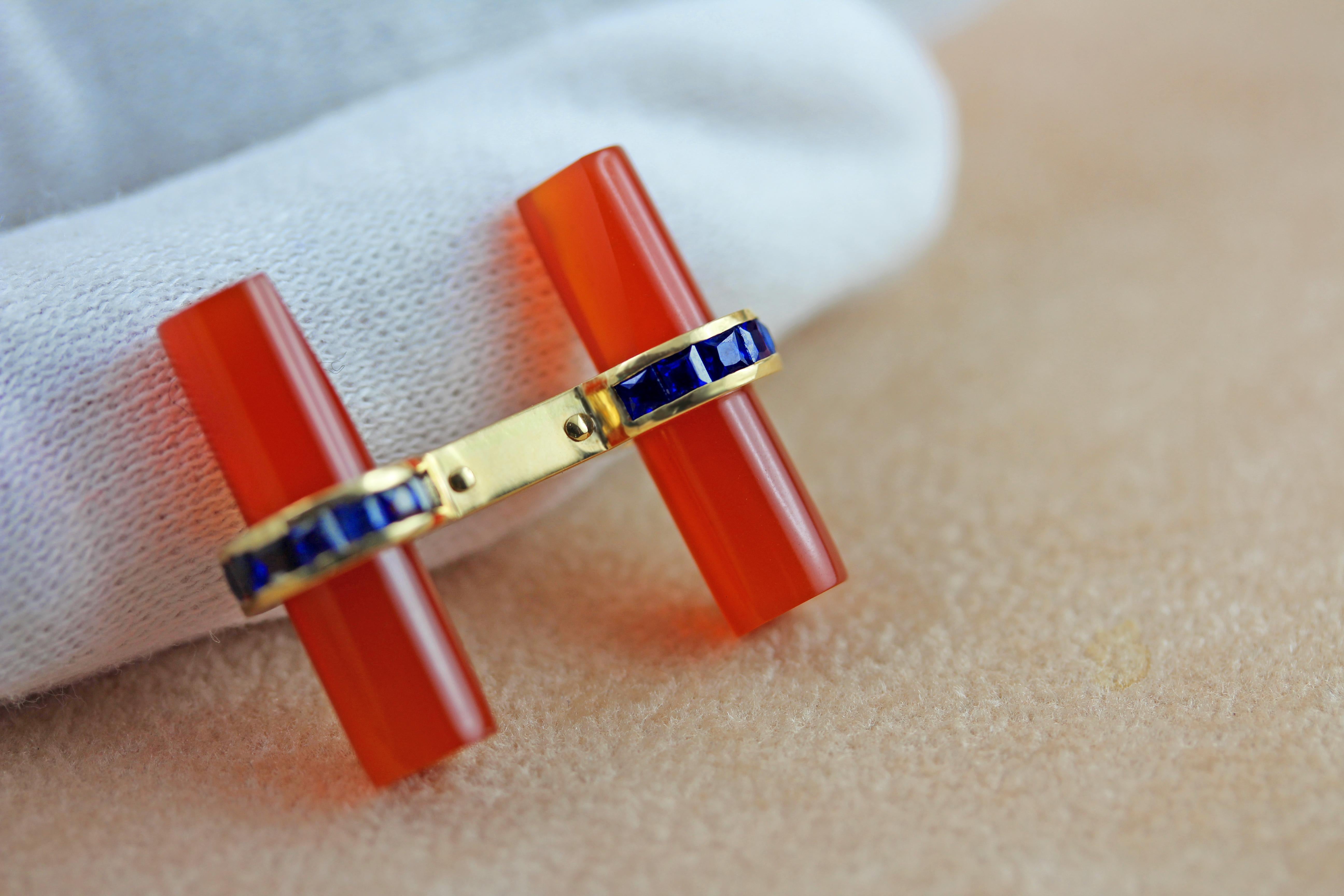 This set of cufflinks is made of three different pair of cylindrical elements that can be mixed and matched to create colorful and elegant combinations. 
The mounting in 18 karat yellow gold is adorned with baguette-cut sapphires.  

The cylinders