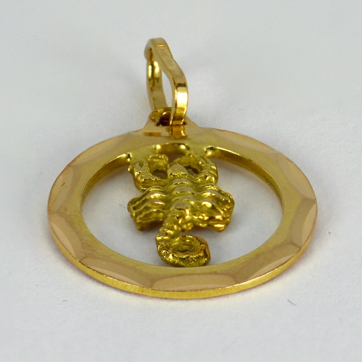 An 18 karat (18K) yellow gold charm pendant designed as the zodiac sign of Scorpio, depicting a three-dimensional scorpion in a round frame. Stamped with the French import mark for 18 karat gold and marked 750.

Dimensions: 2 x 1.8 x 0.15 cm (not