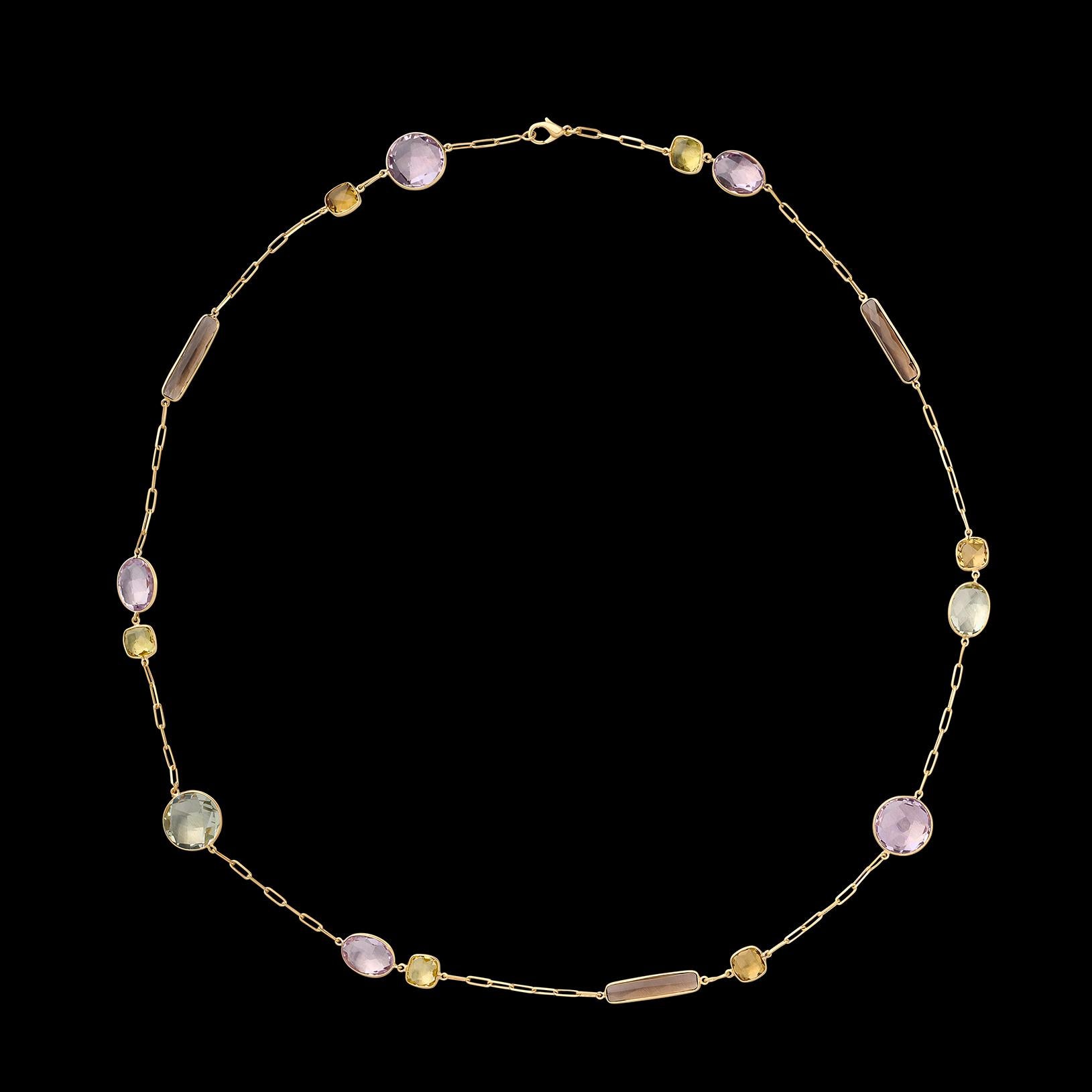 As pretty a piece of fashion jewelry as you're likely to find. This 18 karat yellow gold necklace features 16 eye-catching semi-precious stones bezel set around this link chain. The assortment of stones are vibrant purples, greens, and blues spaced