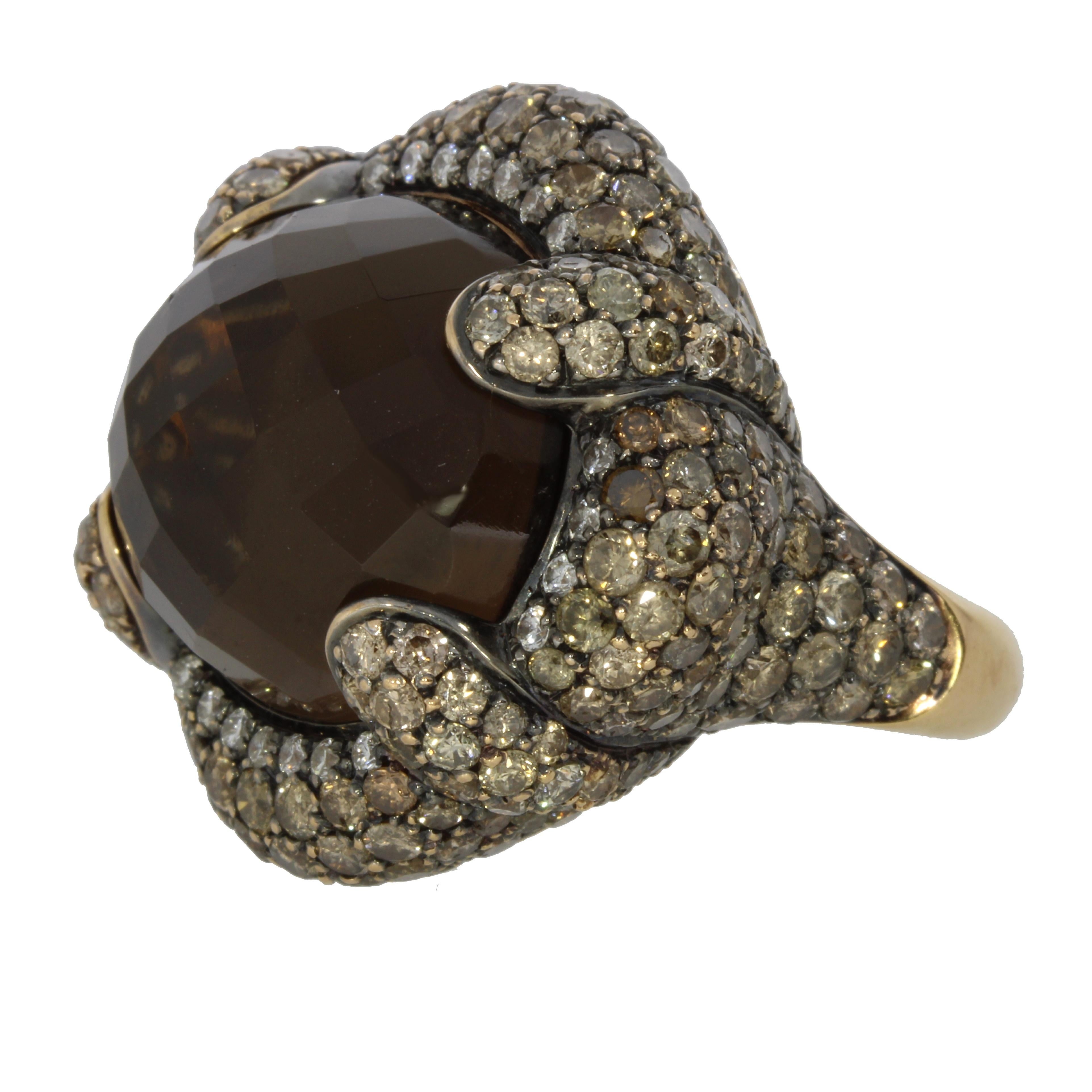 A faceted smokey quartz cabochon sumptuously nestled amongst a pave setting of elegant brown and white brilliant cut diamonds.

Venice Ring Details:
18 Karat Yellow Gold
47.64 Carat Chaker Cut Smokey Quartz
7.20 Carat Brown Diamonds
1.13 White