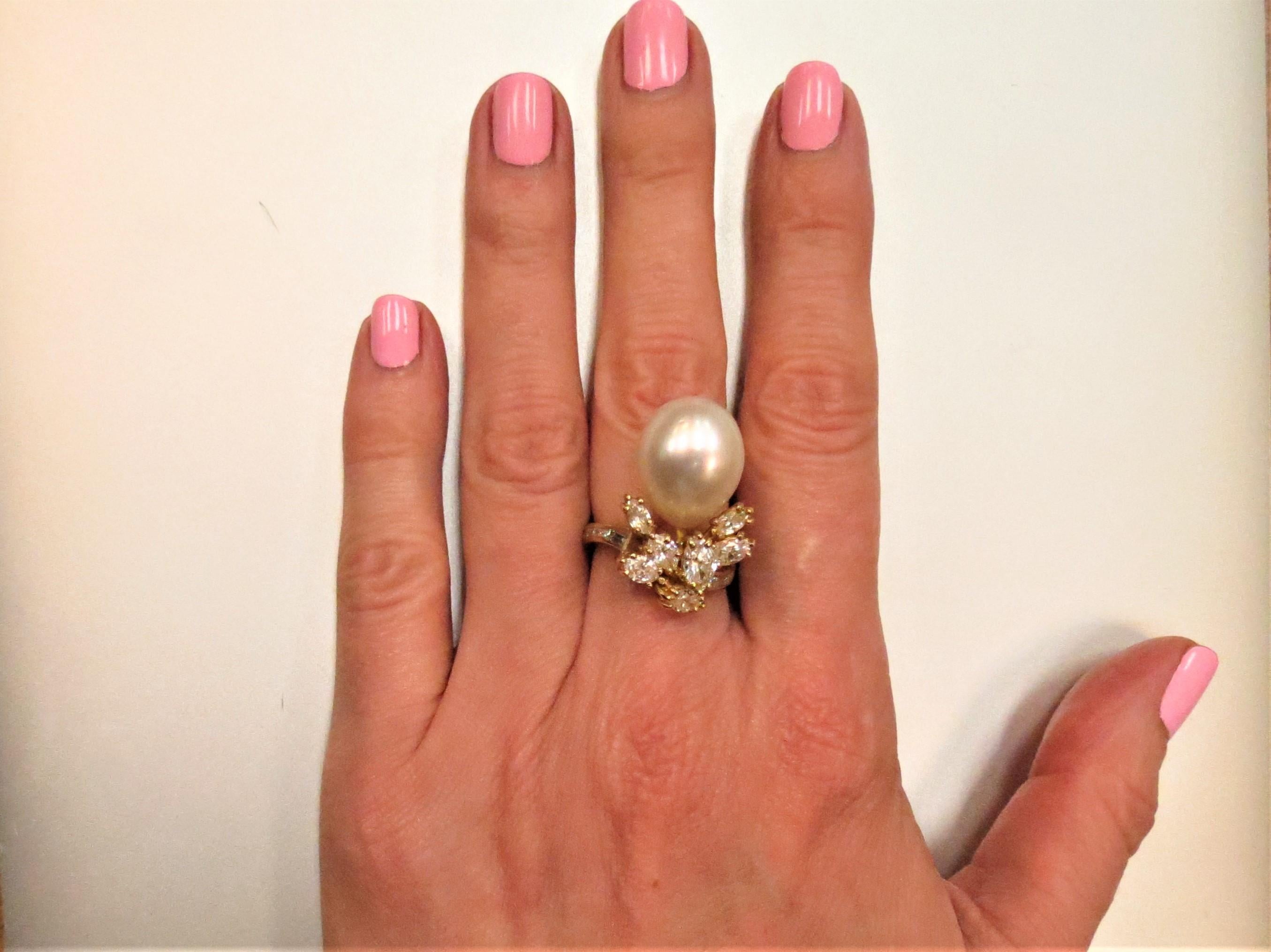 18K yellow gold, South Sea Pearl and diamond ring, prong set with seven marquise diamonds weighing 1.71cts, G-H color, VS clarity, and channel set with eight baguette diamonds weighing .30cts, G-H color, VS clarity and one pear shape South Sea Pearl
