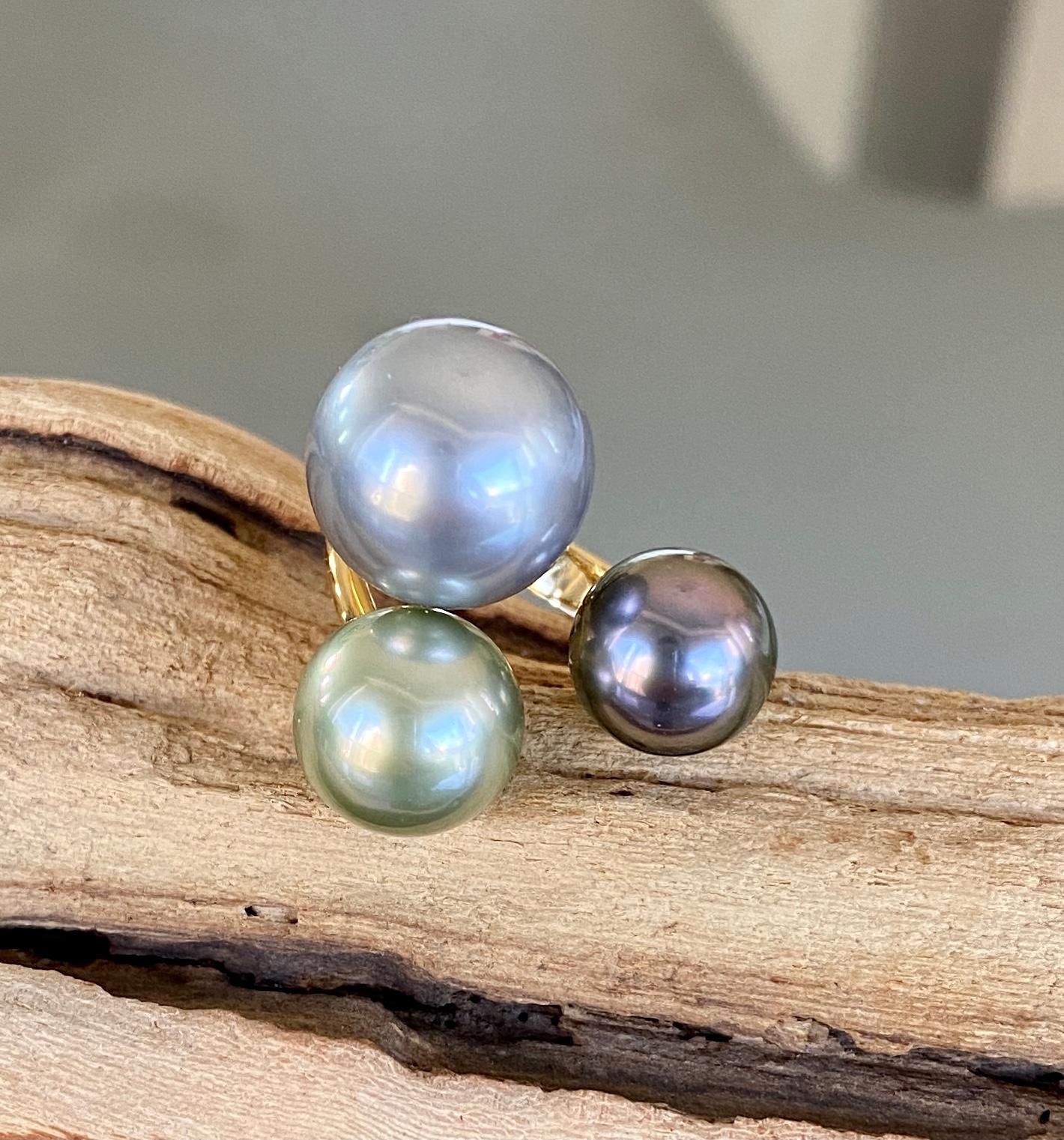 One-of-a-kind South Sea Tahitian cluster pearl ring with three different sizes (13, 10, 9 mm) of pearls in gorgeous hues of grey and rare fancy green and purple, handcrafted in 18 karat yellow gold. US size 6.

This amazing cocktail ring looks like