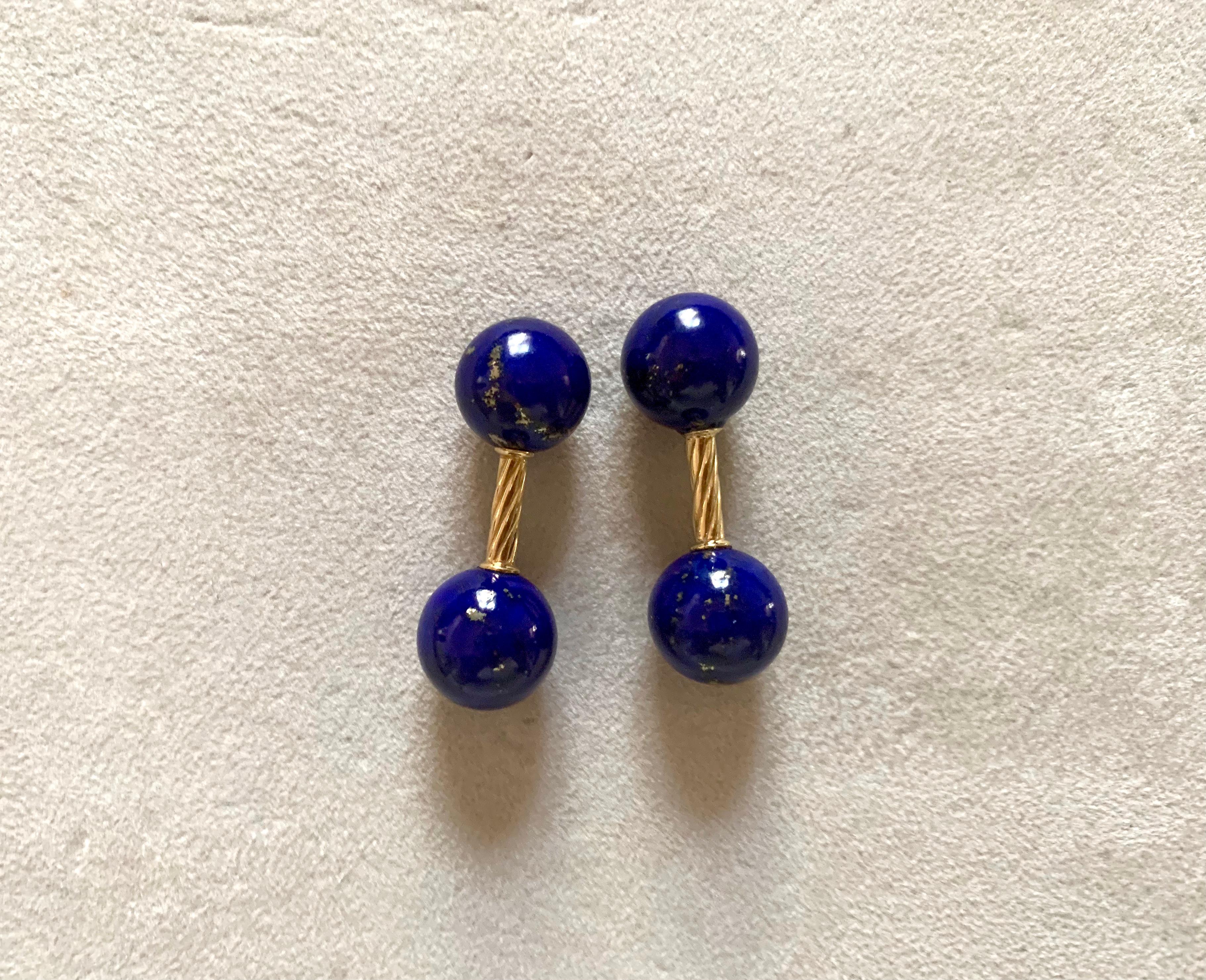 Simple and timeless, these cufflinks are a classic addition to any attire. Their front face and toggle are identical and are carved in a spherical shape out of lapis lazuli, whose dark blue shade strikingly complements the 18 karat yellow gold of