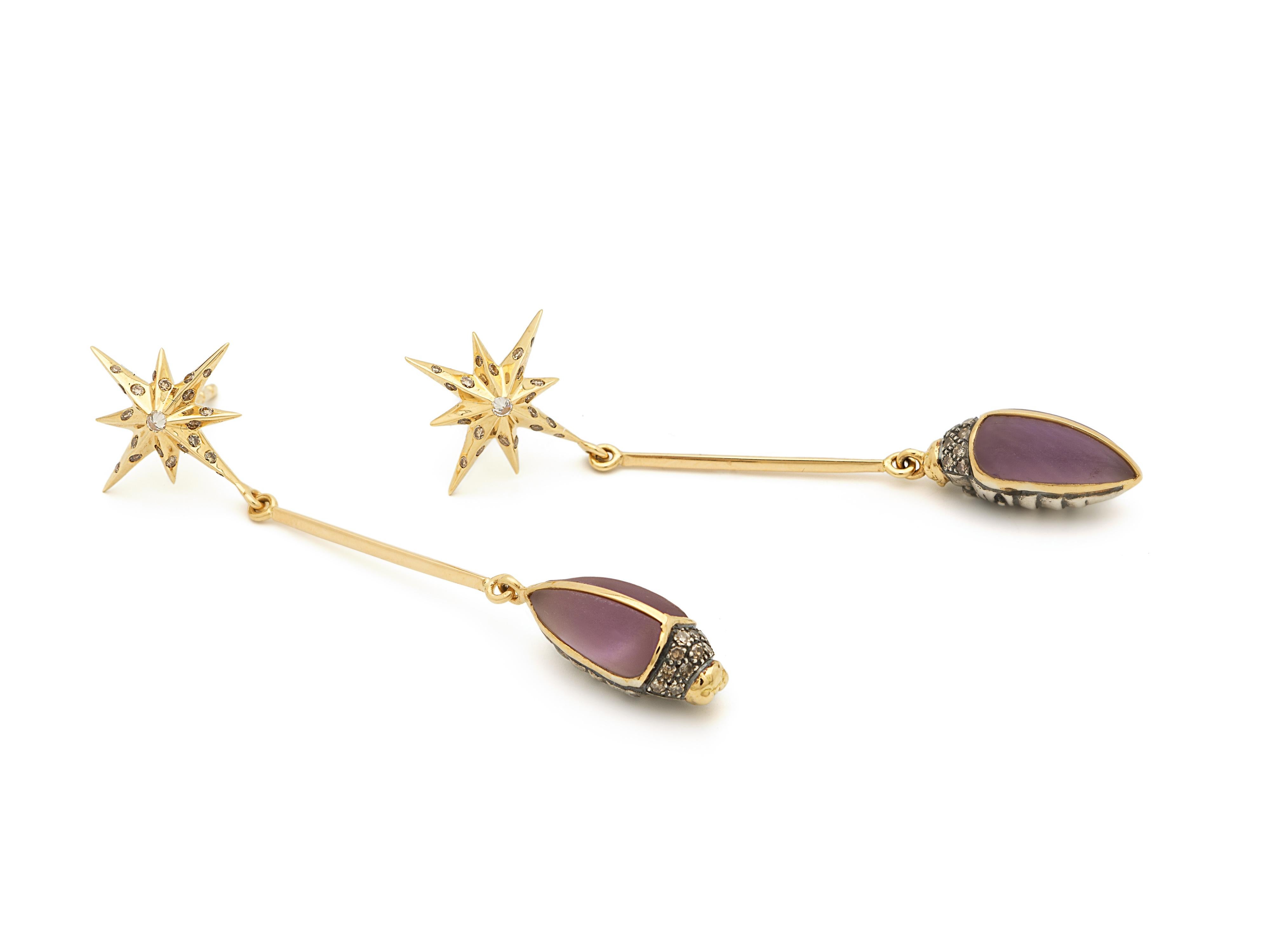 Sleek and graphic, these drop earrings are crafted as fine bars in 18k yellow gold, and are set with dazzling, diamond-embellished star motifs at the posts. The scarab motifs at the drop are fashioned in 18k yellow gold and sterling silver, and set