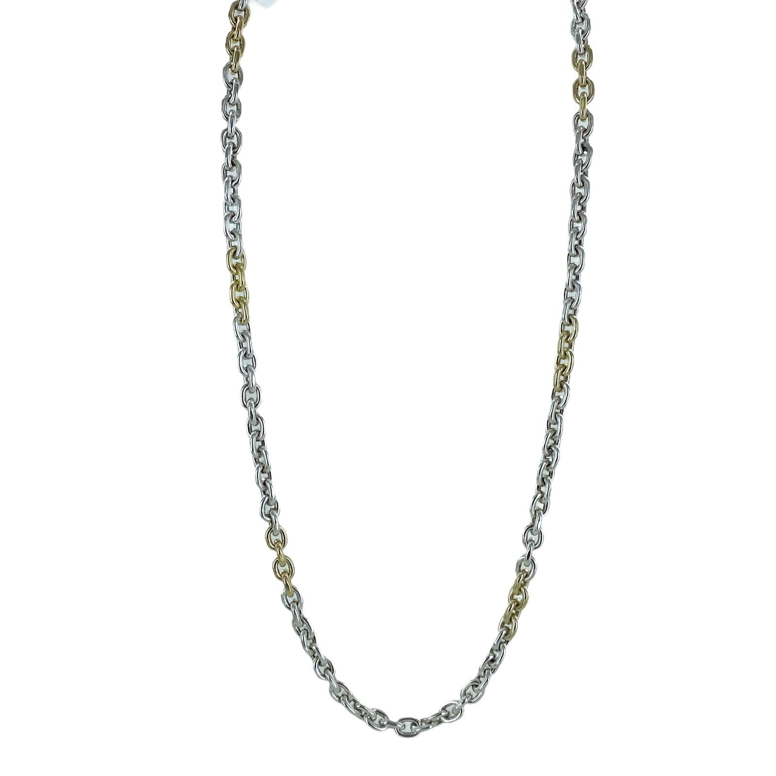 Oval link necklace fashioned in 18 karat yellow gold and sterling silver. The two tone link chain measures 24 inches in length. 