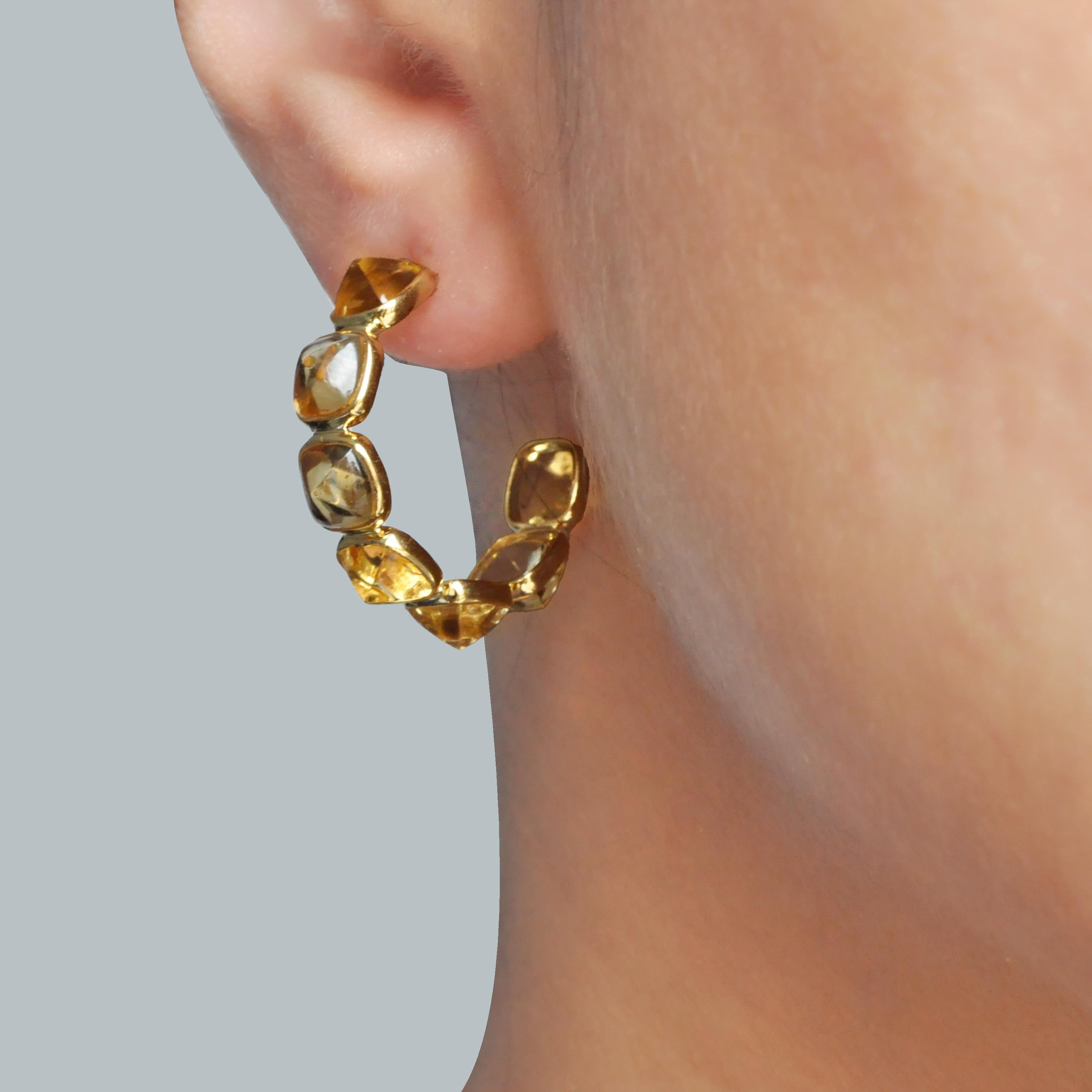 18K yellow gold ombre citrine sugar loaf cut bezel set hoop earring.

These elegant 18k gold citrine hoop earrings are a true masterpiece of craftsmanship and design. Each earring is adorned with a series of meticulously cut in sugar loaf shaped