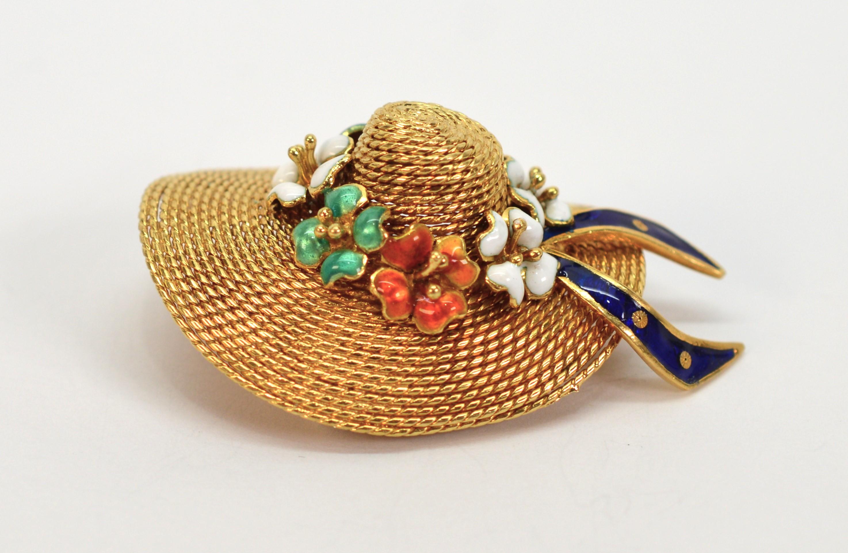 Simply adorable describes this expertly crafted Italian made 18 karat yellow gold brooch capturing the contour and texture of a wide brimmed straw sun bonnet or garden hat that is enhanced with a ring of cheerful, hand painted enamel flowers.