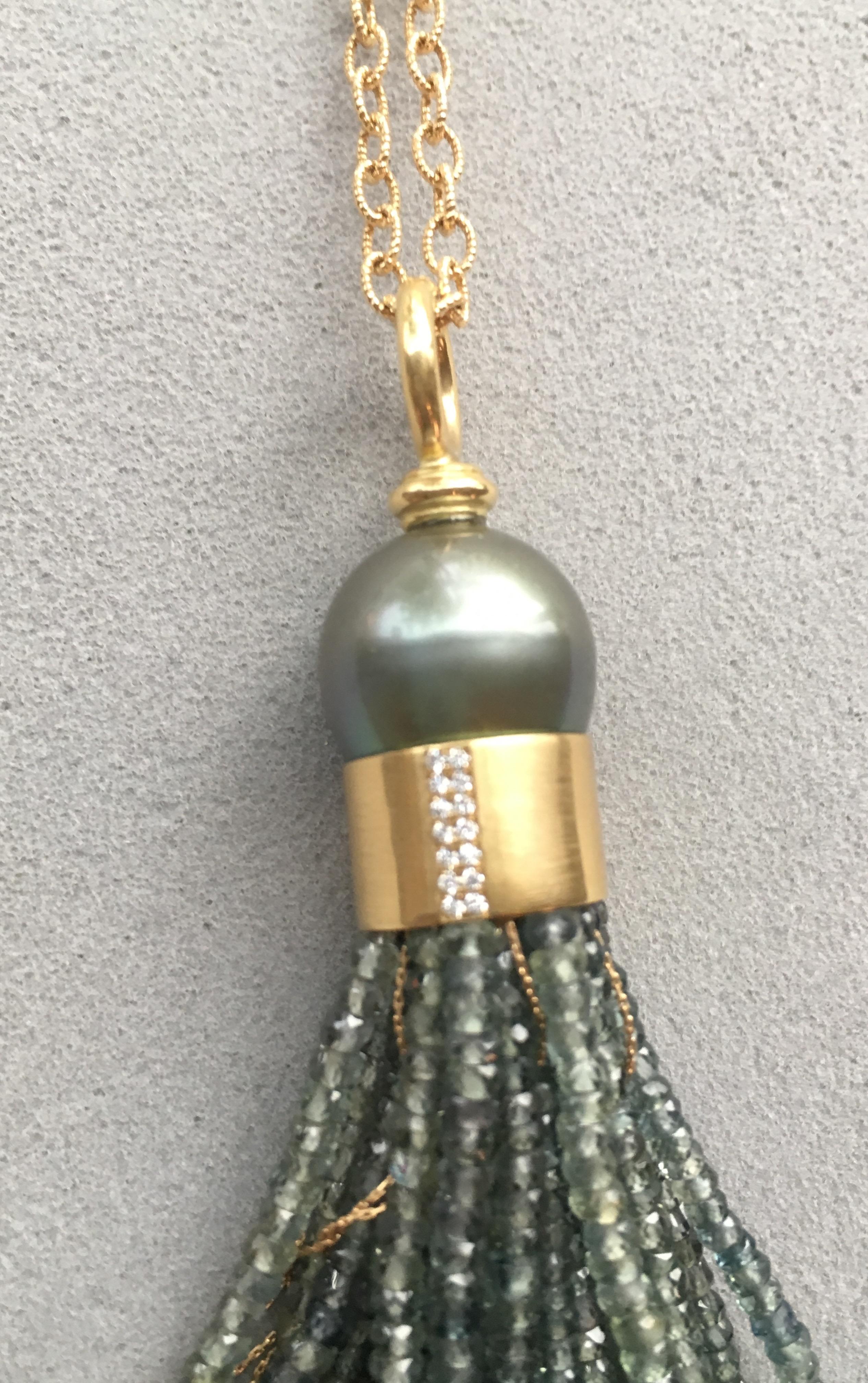 A fabulous 18 Karat yellow gold tassel with a pistachio Tahitian pearl.  Can be dressed  up or down and a favourite for all ages.

The tassel has a 14mm pistachio color Tahitian pearl, beautiful green sapphire beads intertwined with thin gold chain