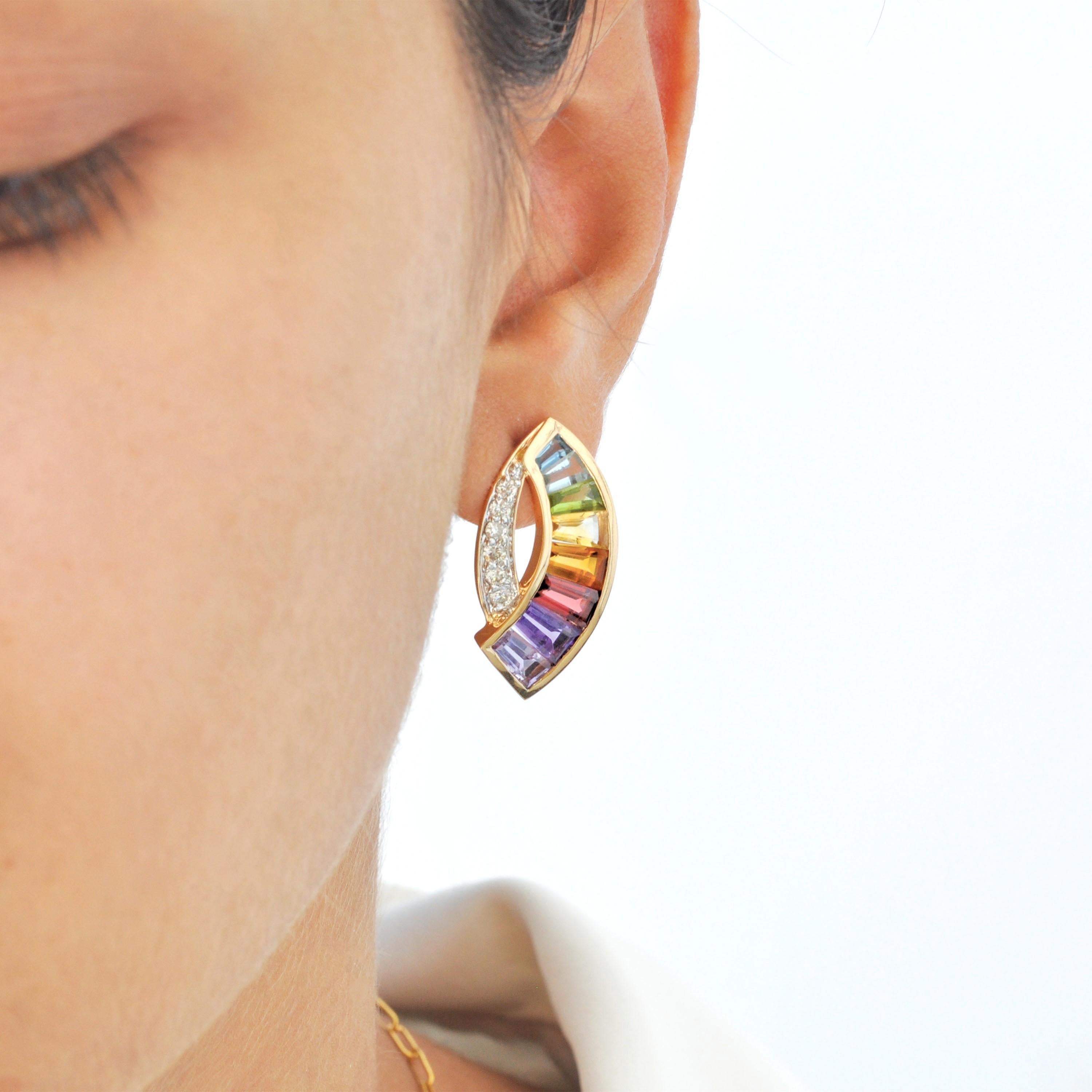 18 karat yellow gold taper baguette rainbow gemstones modern curve stud earrings. 

Introducing our exquisite rainbow sickle diamond stud earrings, a true marvel in the world of fine jewelry. These earrings are a mesmerizing fusion of sophistication