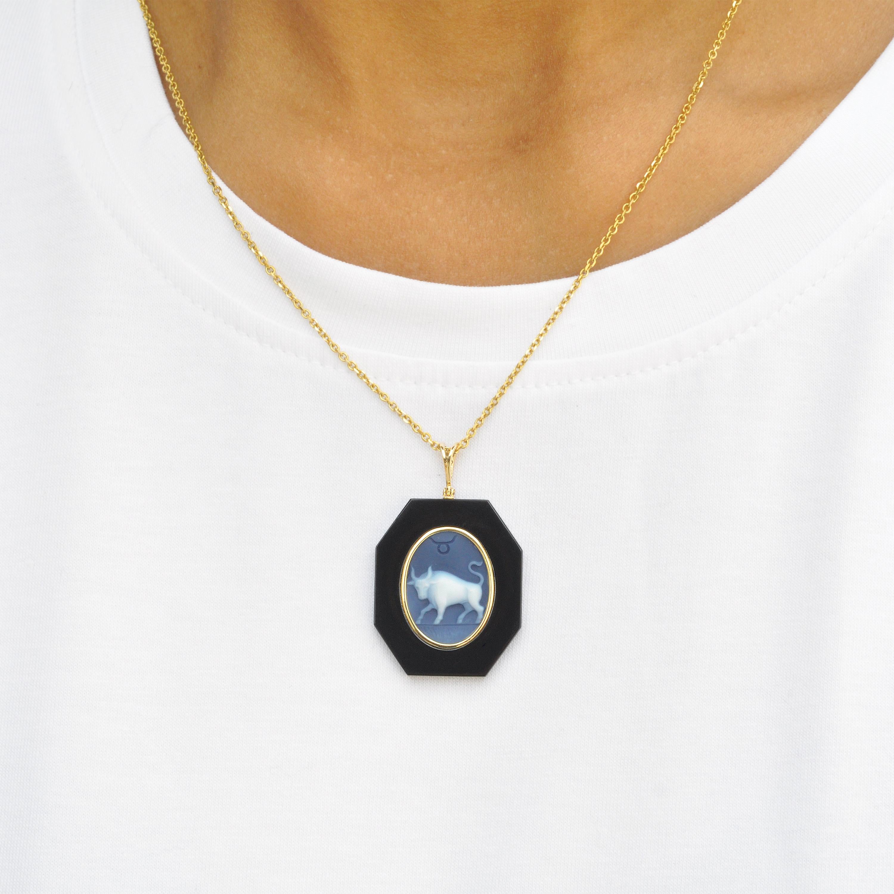 18 karat yellow gold taurus zodiac agate cameo black onyx pendant necklace. 

This exquisite pendant showcases a stunning combination of contemporary design and timeless elegance. Crafted in 18K gold, the piece features a sleek loop from which