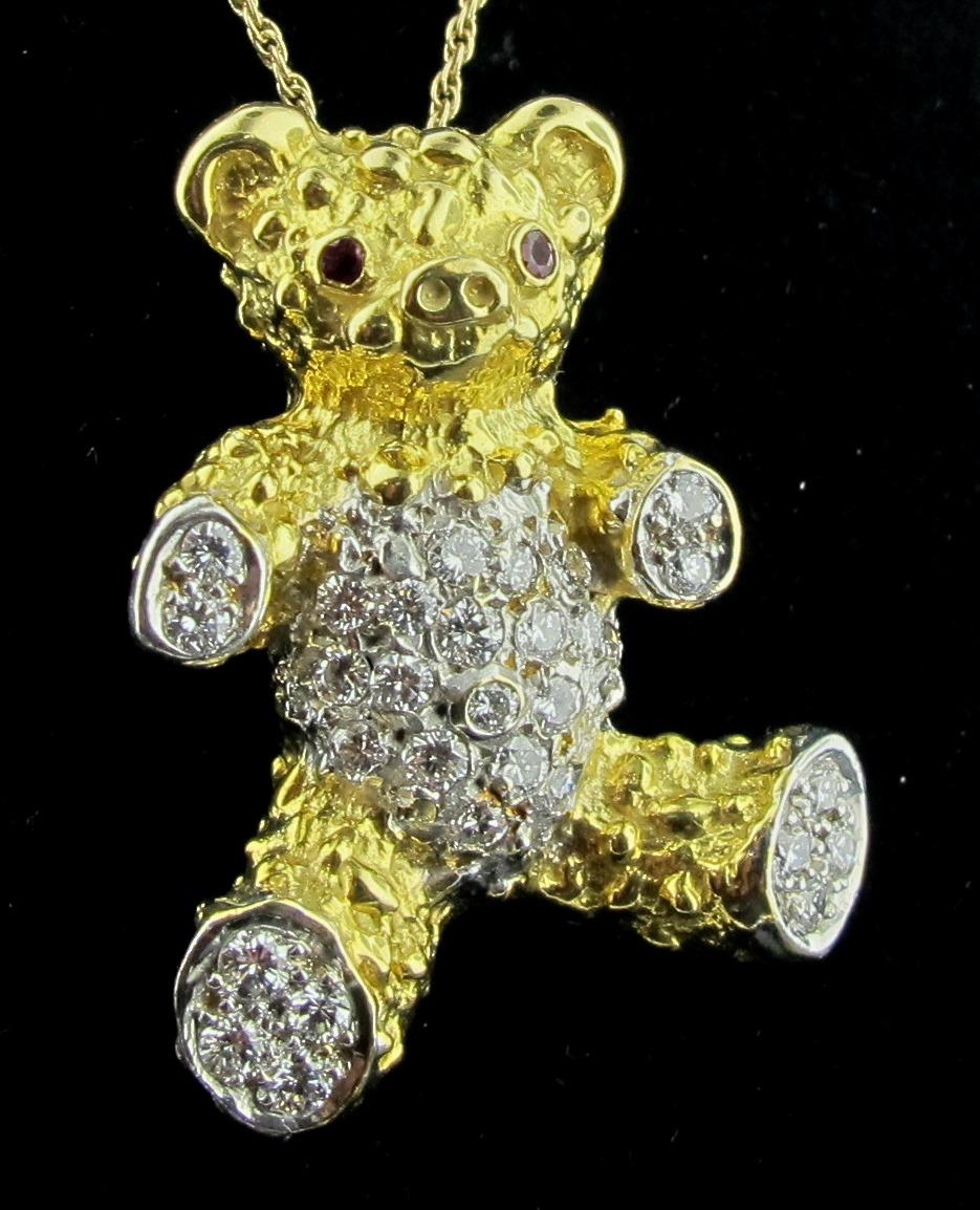This Teddy Bear necklace is set in 18 karat yellow gold, with a weight of 10.6 grams.  It is enhanced with 30 round brilliant cut diamonds, with a total diamond weight of 0.75 carats.  2 Rubies in the eyes.