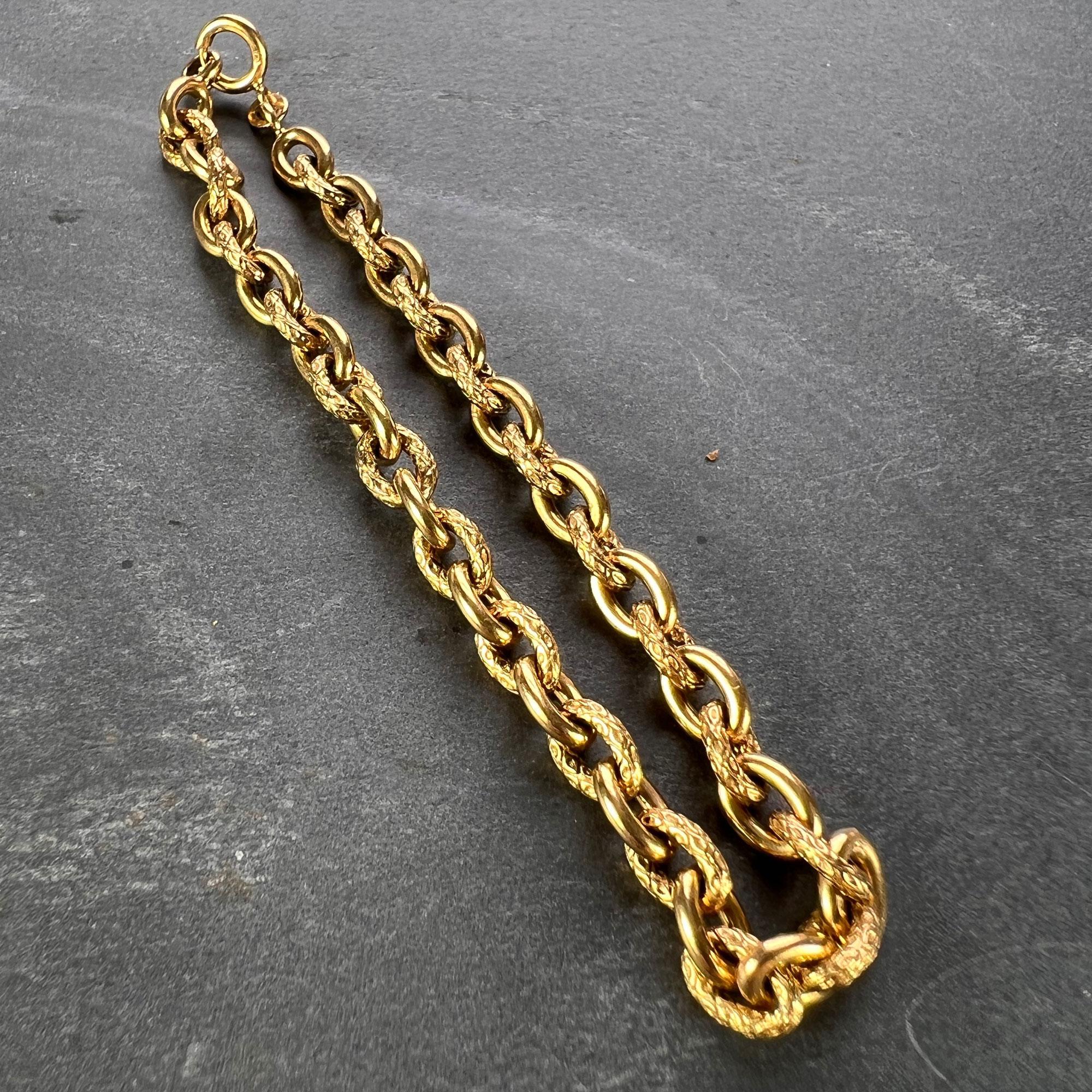 An 18 karat (18K) yellow gold cable link bracelet with alternating textured and smooth links. Marked 750 to the spring ring for 18 karat gold, with French import marks. 7 inches long.

Dimensions: 18 x 0.5 x 0.5 cm
Weight: 14.41 grams 
