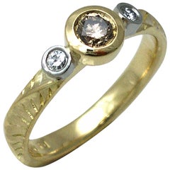 18 Karat Yellow Gold Three-Stone Ring Featuring 0.25 Carat Center Brown Diamond