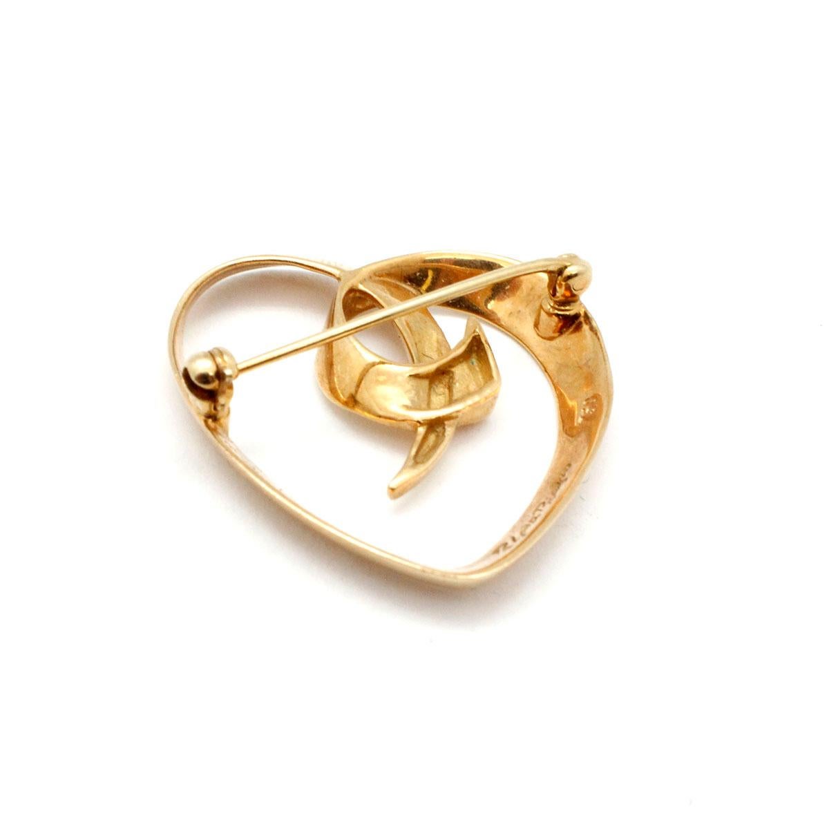 This necklace is 100% original Tiffany & Co by designer Paloma Picasso.
The 18 karat yellow gold heart pin measures 30x27mm. It is stamped “T&CO Paloma Picasso” The pin weighs 6.7 grams. There is no accompanying paperwork. 
