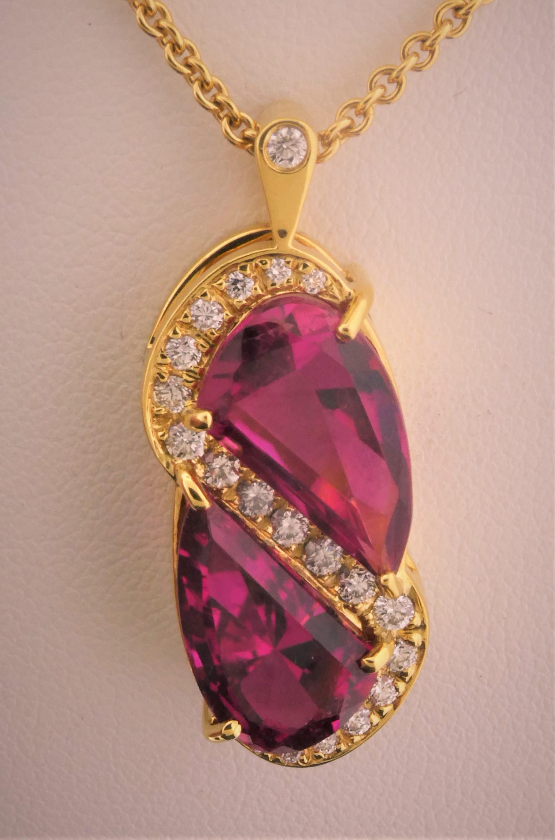 I can only take credit for the design of the pendant, but mother nature has brought forth this remarkable pair of Fuchsia color Tourmalines that weigh 11.40 carats and are completely clean.  Nestled in an 18 Karat yellow gold mounting with a spray