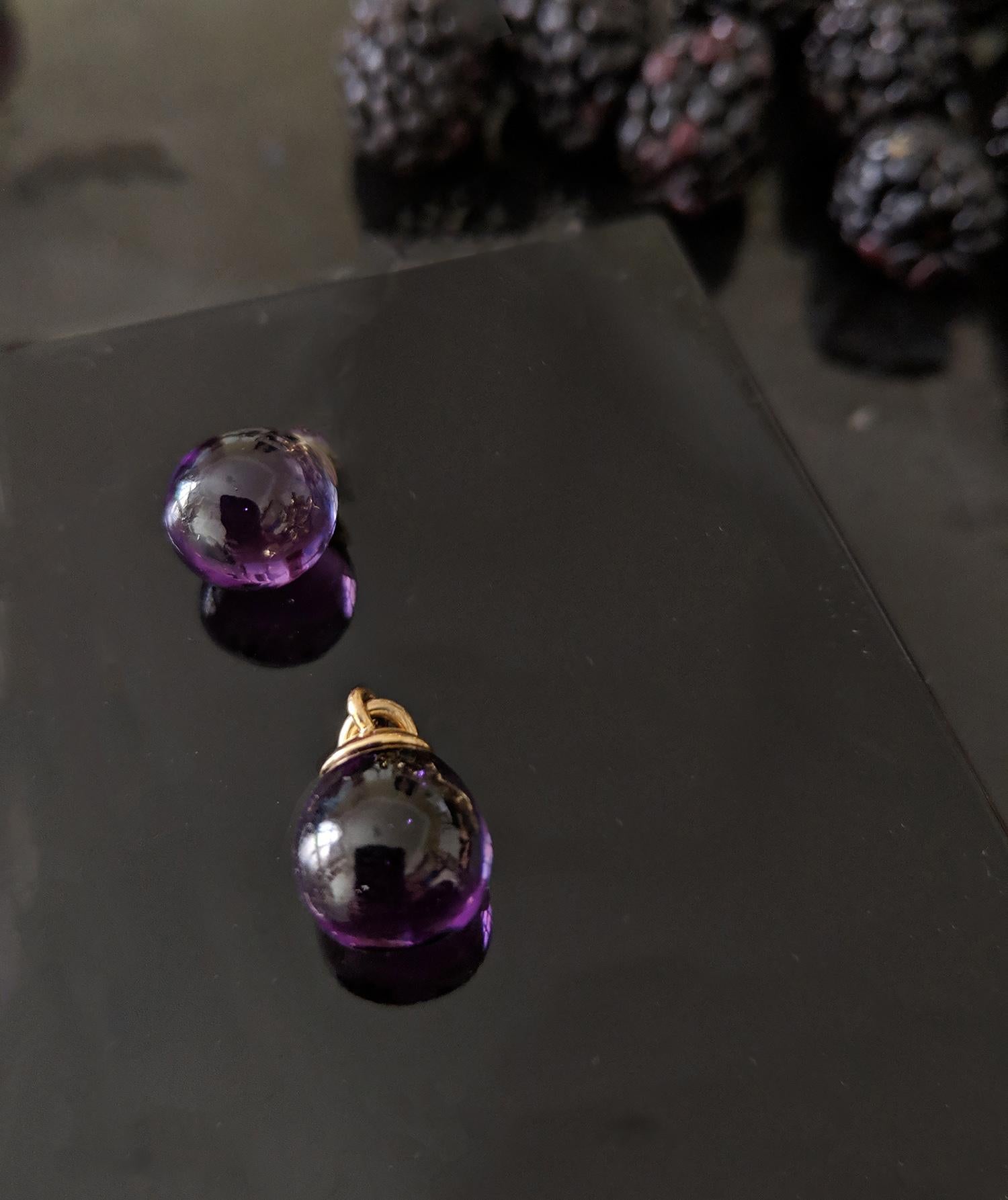 These contemporary transformer drop earrings are made of 18 karat yellow gold with detachable natural amethyst drops and morganites in octagon cut, weighing 6.61 carats in total (10x8 mm each), and two round diamonds. The earrings are 1.1 inches (27