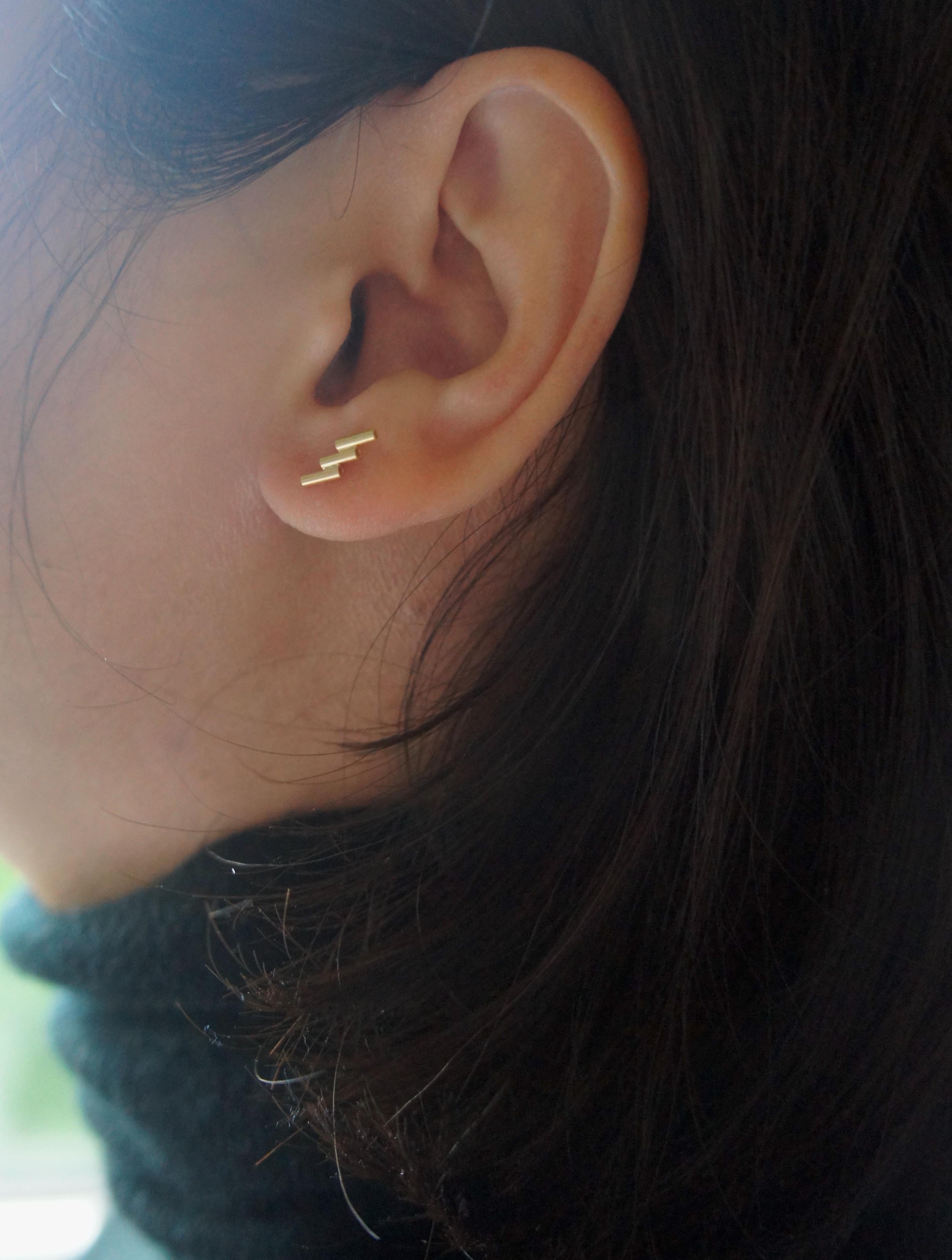 The Making Marks collection presents 18-karat yellow gold stud earrings, featuring the maker's hand-forged marks and a brushed texture. The minimal and playful design of this collection makes it perfect for everyday wear and a great gift option.
