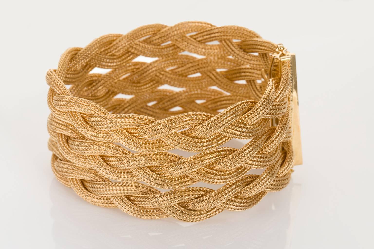 A wonderful creation and a wearable work of art sitting on your arm. An 18 karat yellow gold triple plaited woven flexible bracelet that feels so fabulous on the skin. The look and feel of this bracelet is eye-catching and unique and the detail in