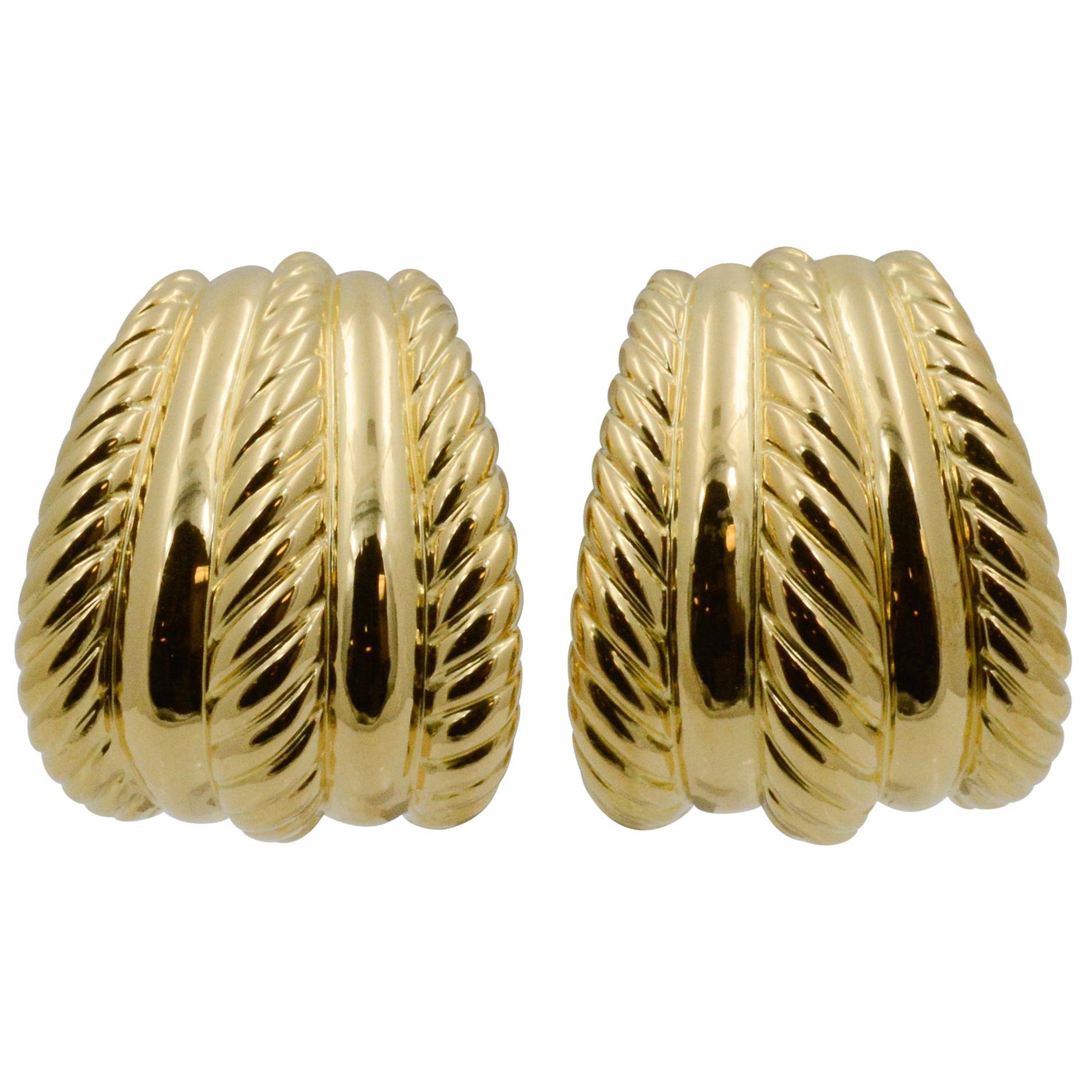 Exclusively from the Eiseman Estate Jewelry Collection, these 18k yellow gold Turi tapered half hoop earrings have four panels, two smooth, two with a rope swirl design. 