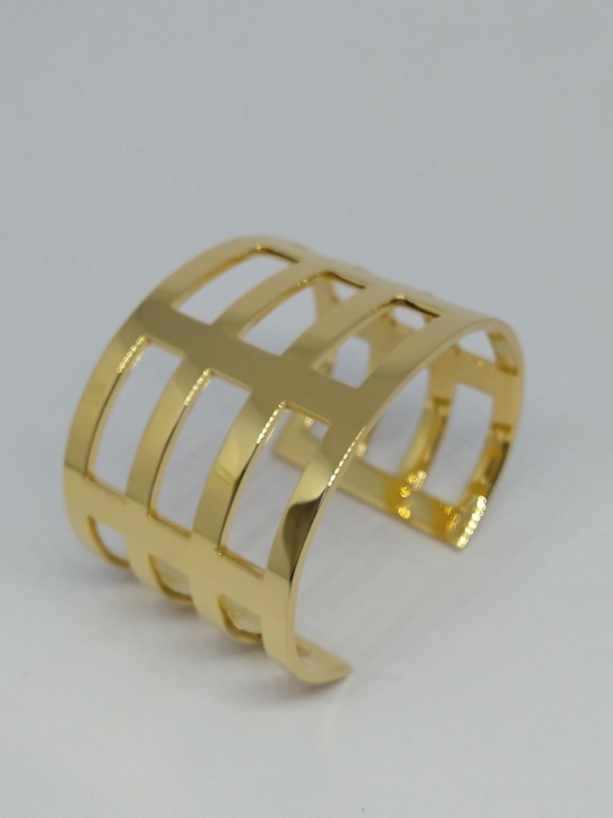 Tiffany designer, Thomas Kurilla designed this after selling original designs to Tiffany's. This wide 18 Karat  Yellow Gold Plated Cuff Bracelet 1 5/8 inch wide and 1.75 mm  thick with fifteen rectangle openings. From my graphic, sculptural, and