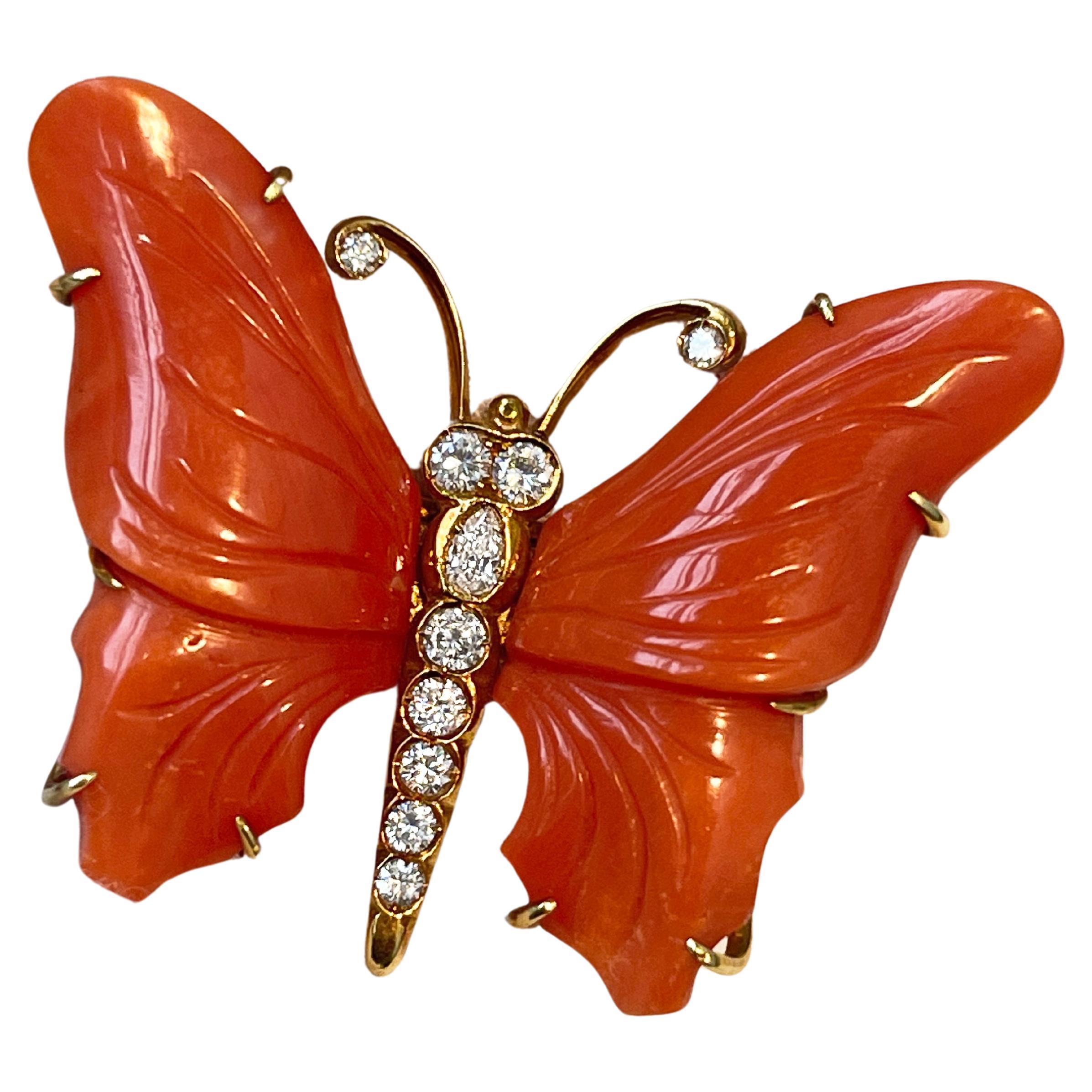 Beautiful vintage butterfly brooch totally hand carved and made in Mediterranean Coral and 18 karat yellow gold is the base, as brilliant cut diamonds embellish the body. 
Golden wire curls for the antennas, accented by a single diamond on the tips.