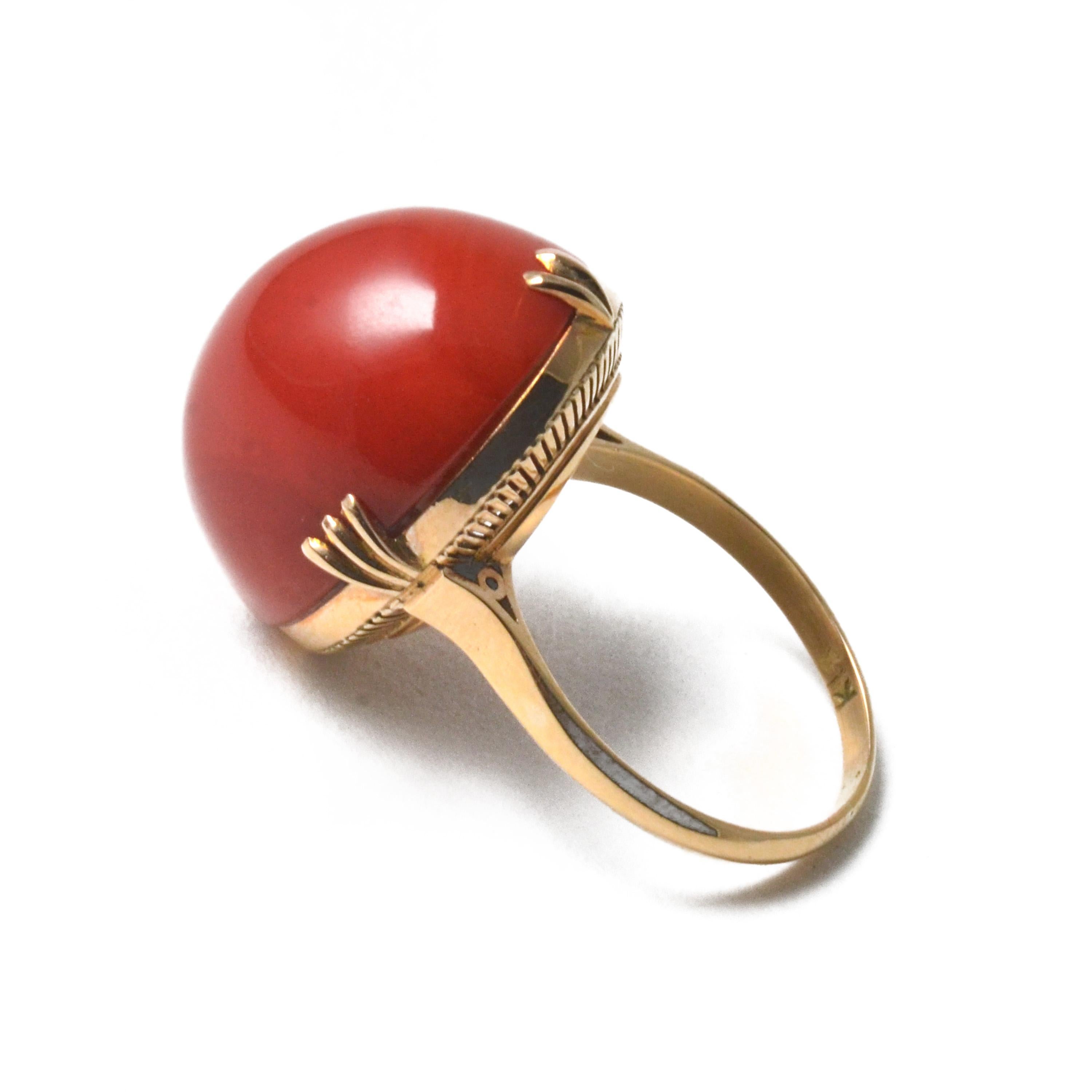 This vintage ring is crafted in 18 karat yellow gold with Chiaka Sango (oxblood coral). The coral is approximately 19 mm wide and matches well with the brilliance of 18 karat yellow gold. This loose coral was made by taking the required dimensions