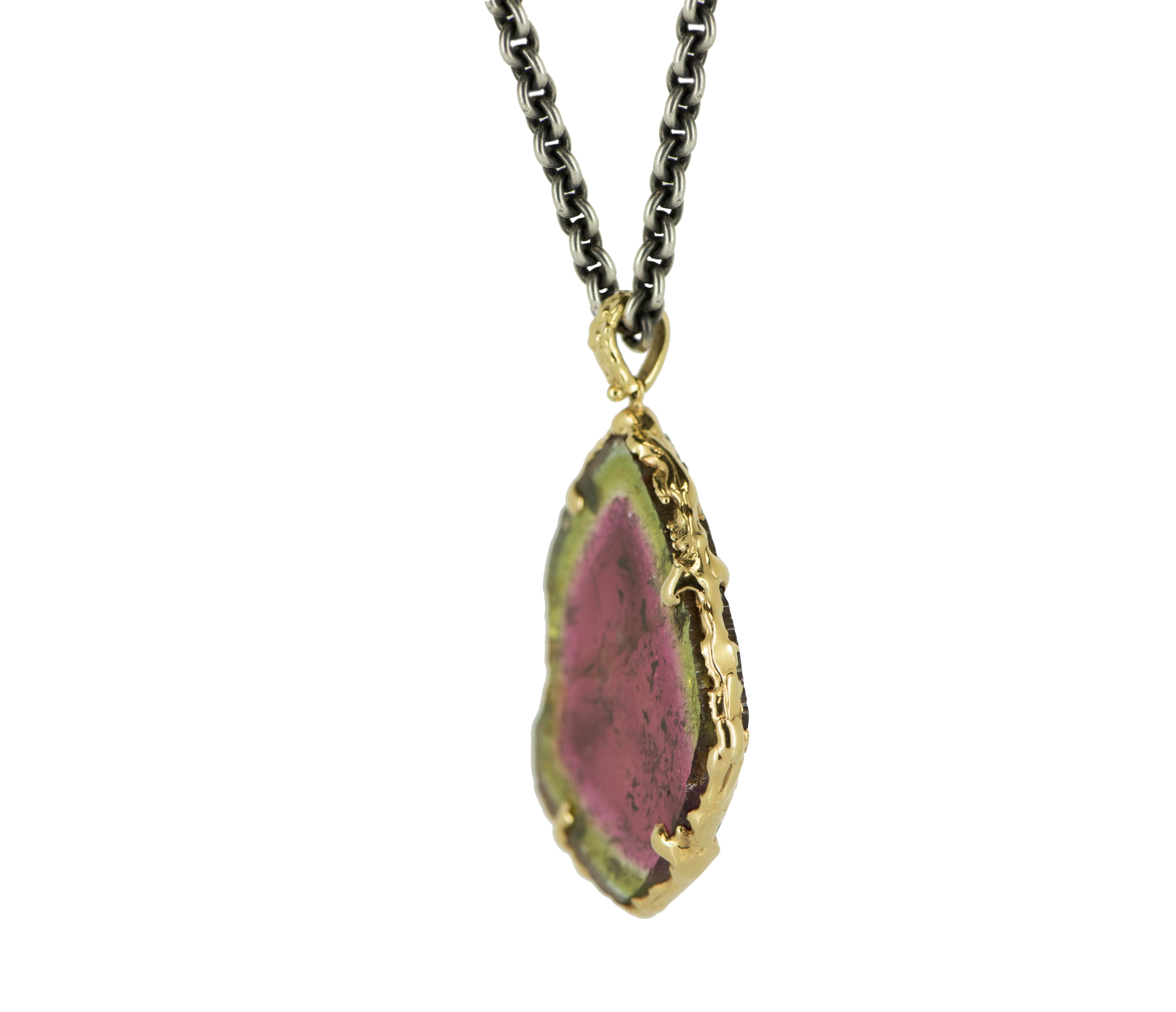 This breathtaking pendant is crafted from the rare and stunning Watermelon Tourmaline, known for its unique and eye-catching colors. Its pink center framed in a green 'rind' creates a playful and vibrant look that is sure to turn heads. Believed to