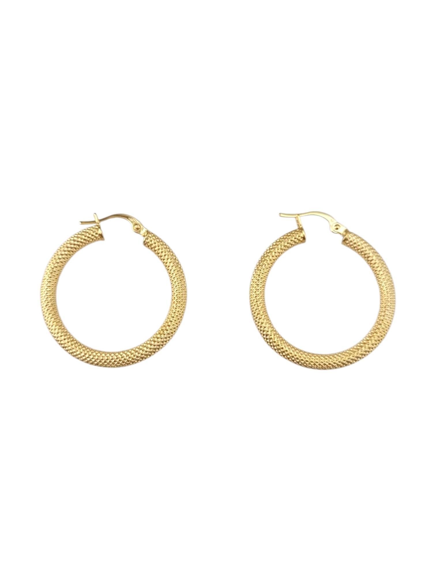 18 Karat Yellow Gold Weaved Hoop Earrings

Crafted from 18-karat yellow gold, these hoop earrings showcase a unique textured surface that adds depth and character. The perfect piece to elevate your everyday look or add a touch of shine for special
