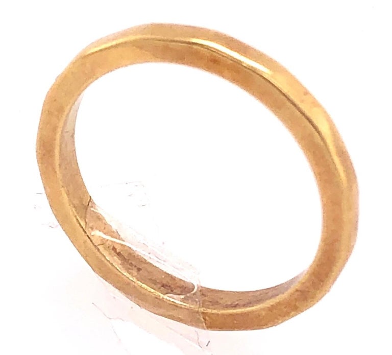 18 Karat Yellow Gold Wedding/Band Ring 
Size 4.5
2.7 grams total weight.