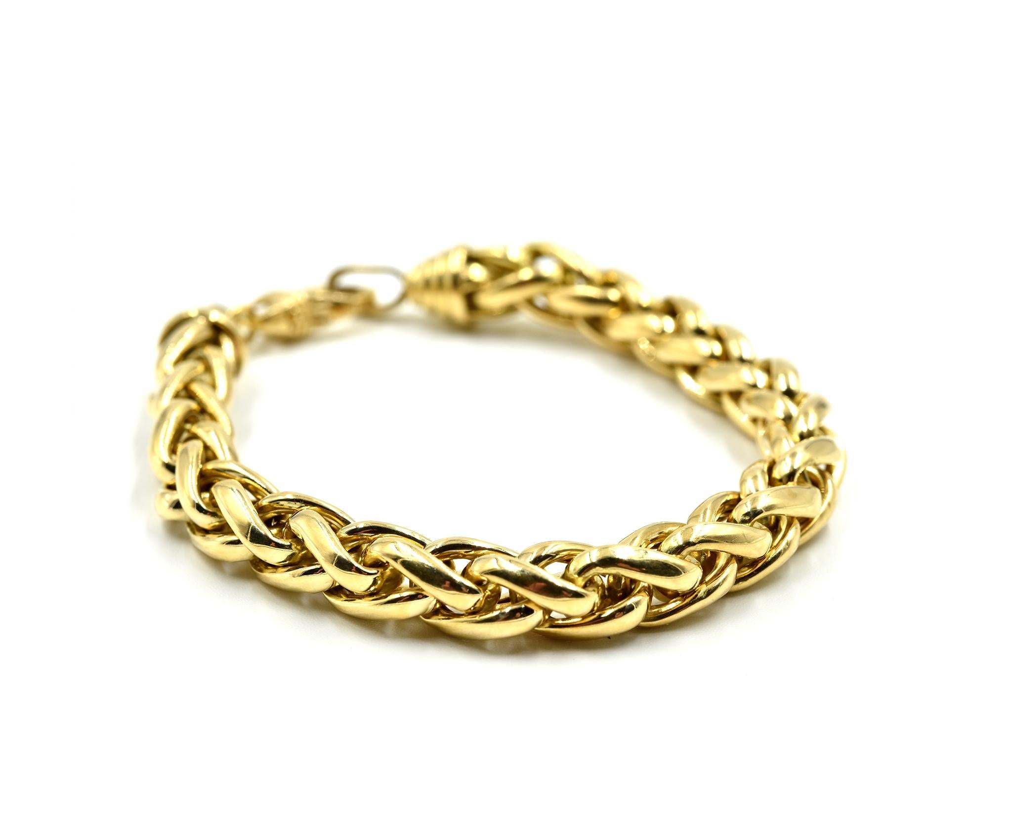 Designer: custom design
Material: 18k yellow gold
Dimensions: bracelet measures 7 3/4-inch long and 1/4-inch wide
Weight: 24.92 grams
