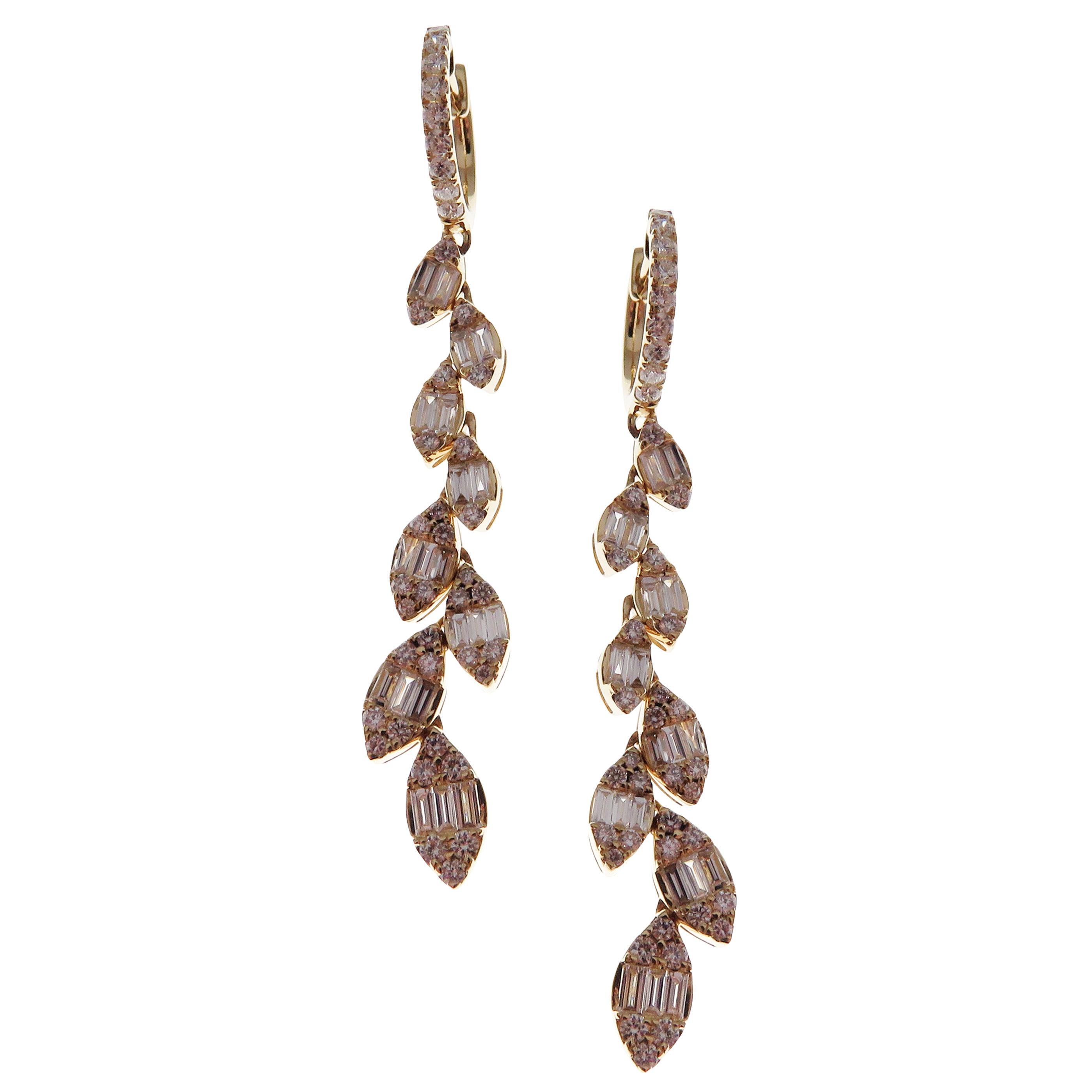 These trendy marquise-shaped linear earrings with white baguette diamonds are crafted in 18-karat yellow gold, featuring 82 round white diamonds totaling of 0.74 carats and 40 baguette white diamonds totaling of 0.67 carats.
These earrings come with