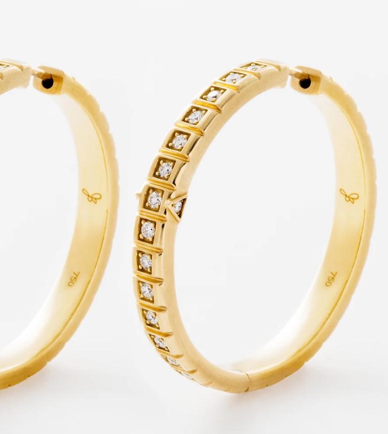 18 Karat Large Carousel Hoops are set in solid 18k Yellow Gold with a single row of white diamonds on each hoop and finished with a seamless secure pop in closure.
18k Yellow Gold, White Diamonds
From the James Banks Code Collection 
