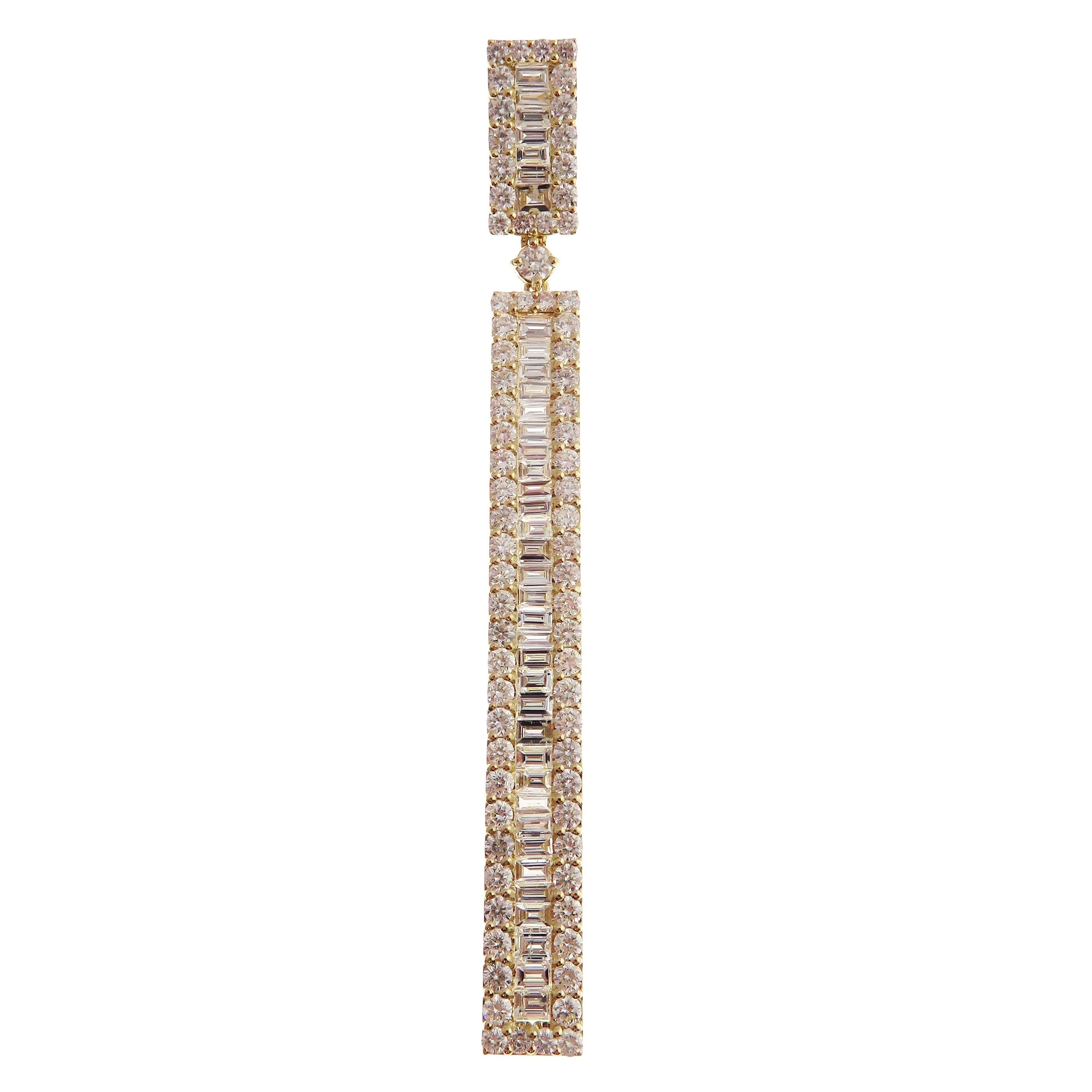 These simple baguette bar earrings are crafted in 18-karat yellow gold, weighing approximately 9.20 total carats of SI-V Quality white diamond. French Clip backing, 3