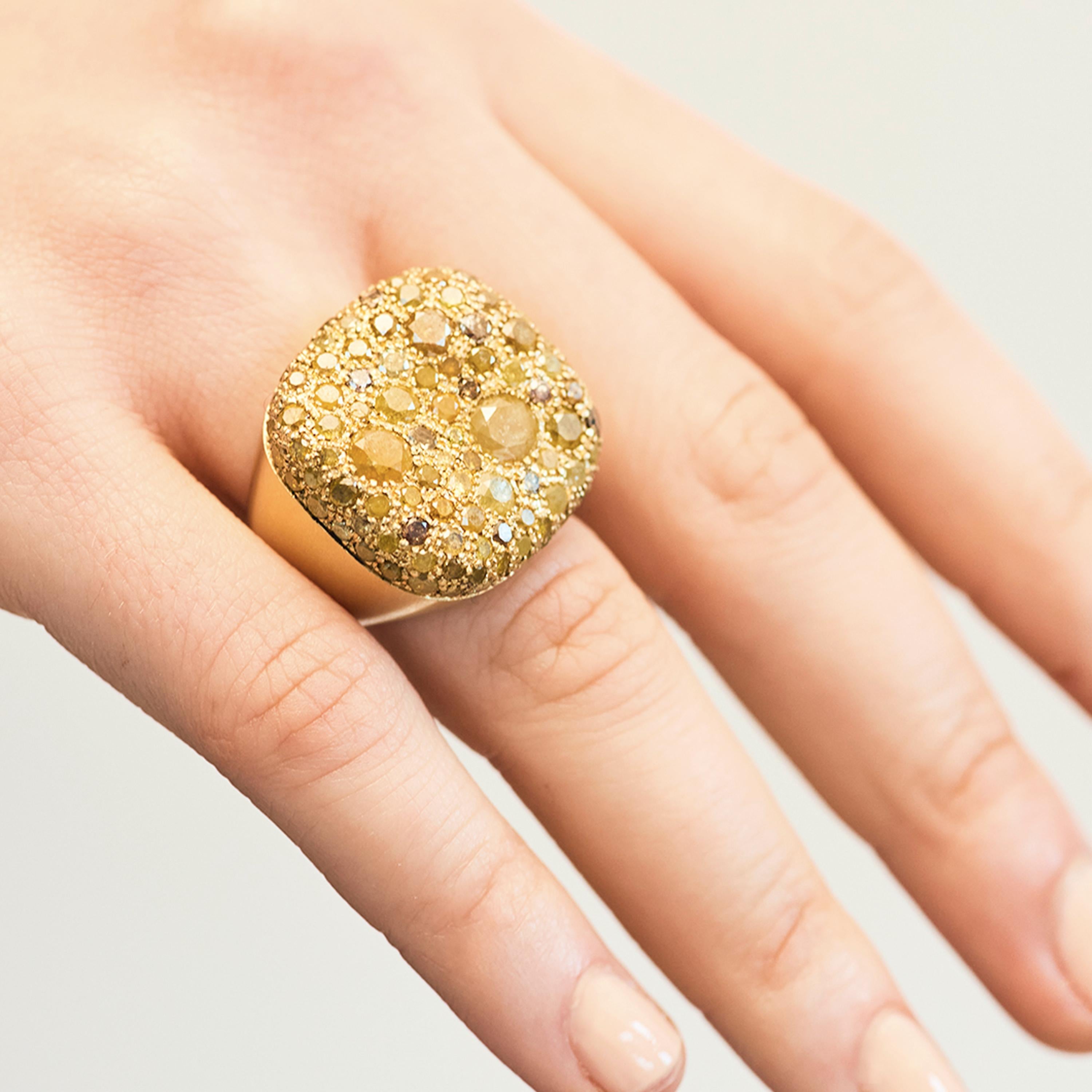 Nada Ghazal's Malak Icy Special Round Ring is crafted from 18 karat yellow gold. Its tactile form is complimented by a brushed surface finish. Nada presents a bold use of colour decorating the piece with white diamonds (6.25cts).

While Nada