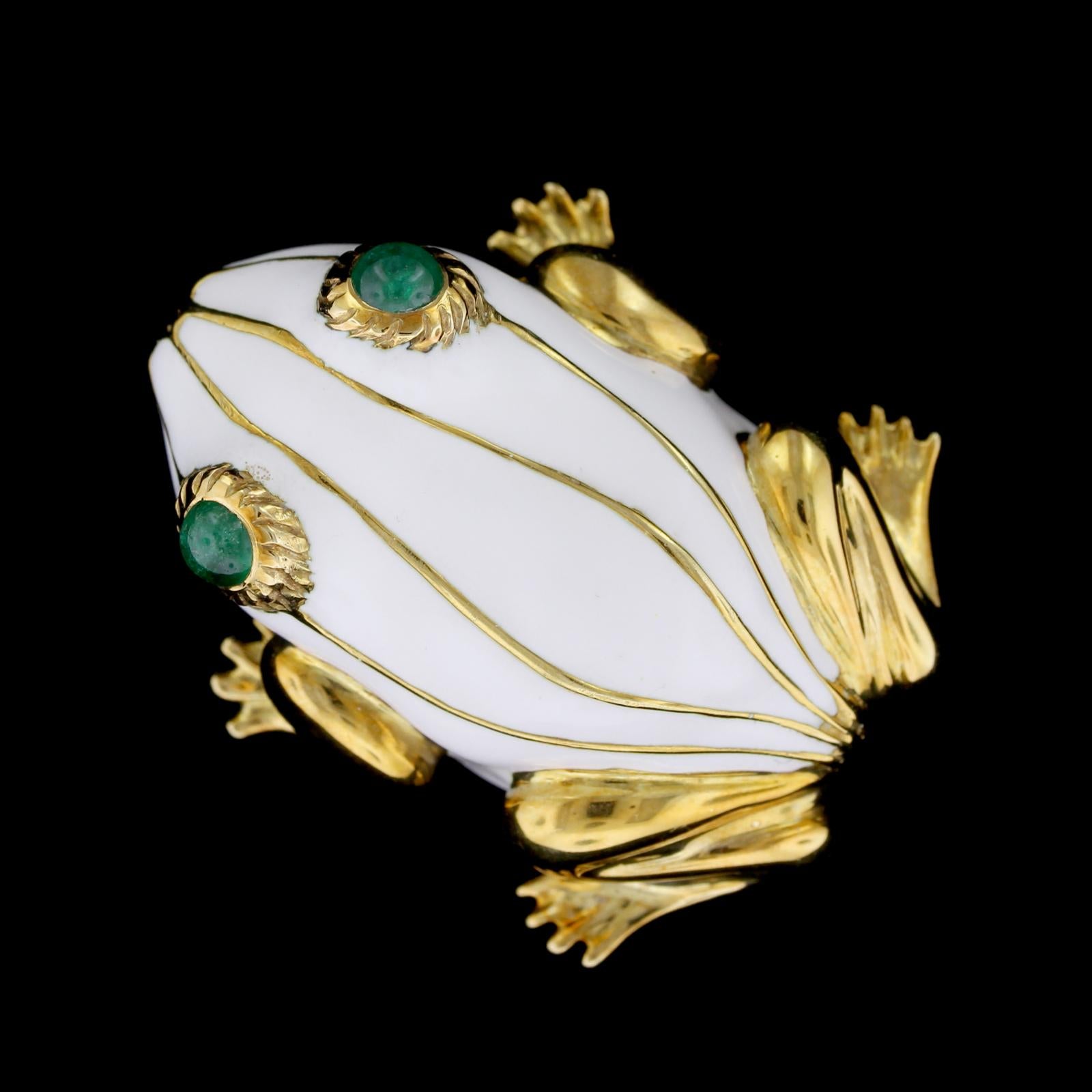 18K Yellow Gold White Enamel and Emerald Frog Brooch. The frog is designed with a
white enamel body and two round cabochon emerald eyes each measuring 4.00mm.,
width 1 1/4
