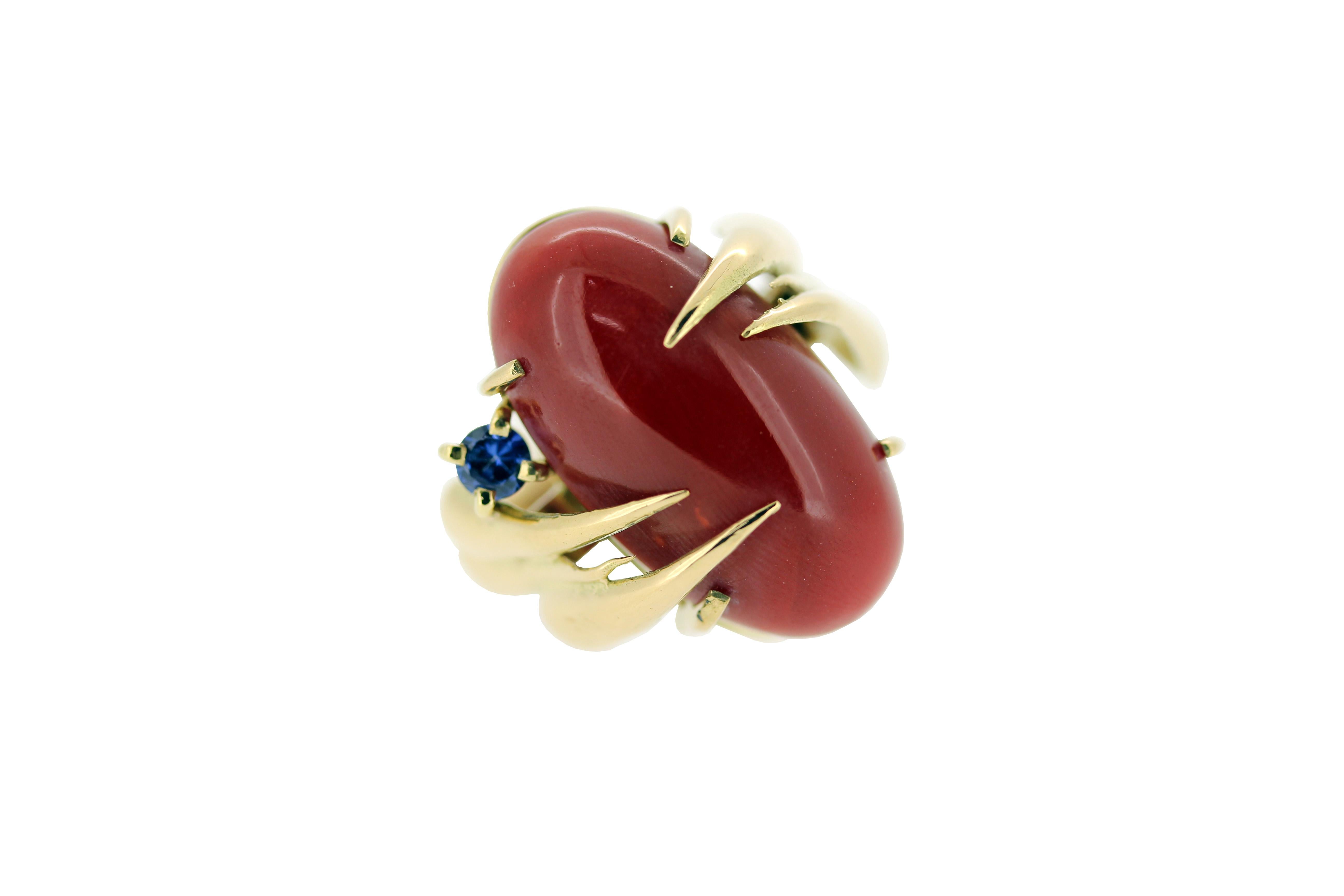 This modern handmade British-London Hallmarked 18 karat yellow gold ring, set with blue sapphire and oval shape cabochon vivid red coral is from MAIKO NAGAYAMA's Haute Couture Collection called 