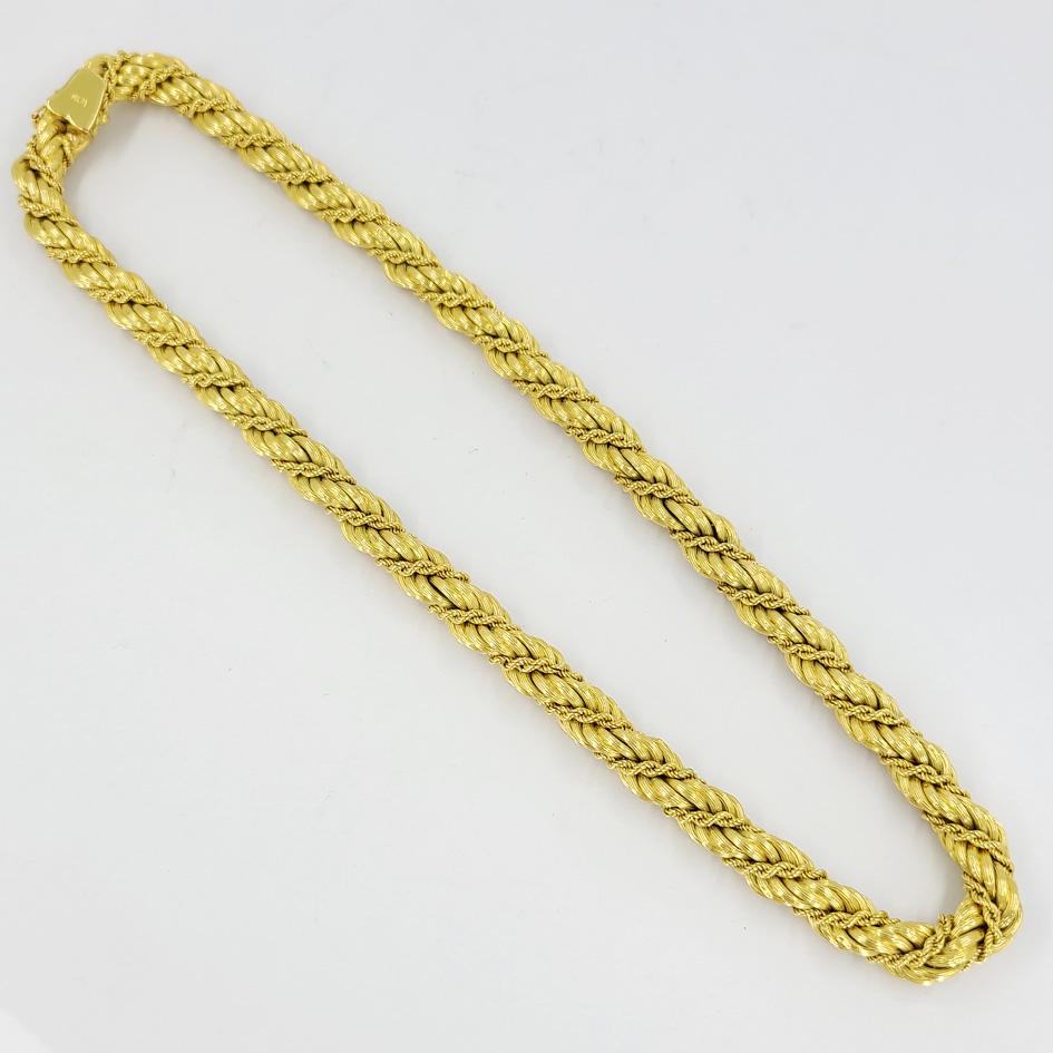 18 Karat Yellow Gold Woven Textured 8mm Rope Chain. 16 Inches Long With Hidden Safety Clasp. Finished Weight Is 60 Grams.