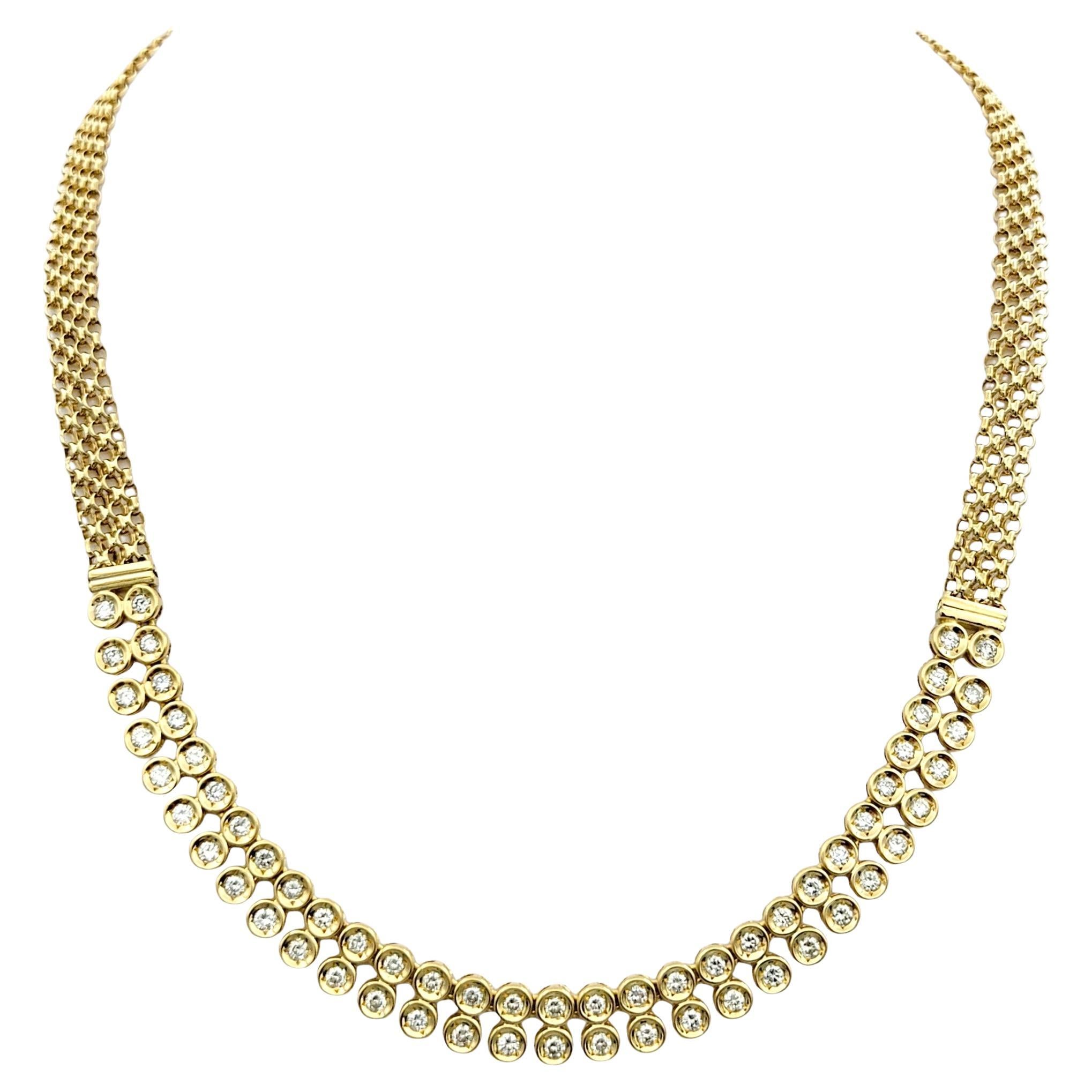 This stunning statement necklace features bezel-set diamonds arranged elegantly along an 18 karat yellow gold chain. Each diamond is securely nestled within its own bezel, creating a sleek and modern look that exudes sophistication.

The bezel