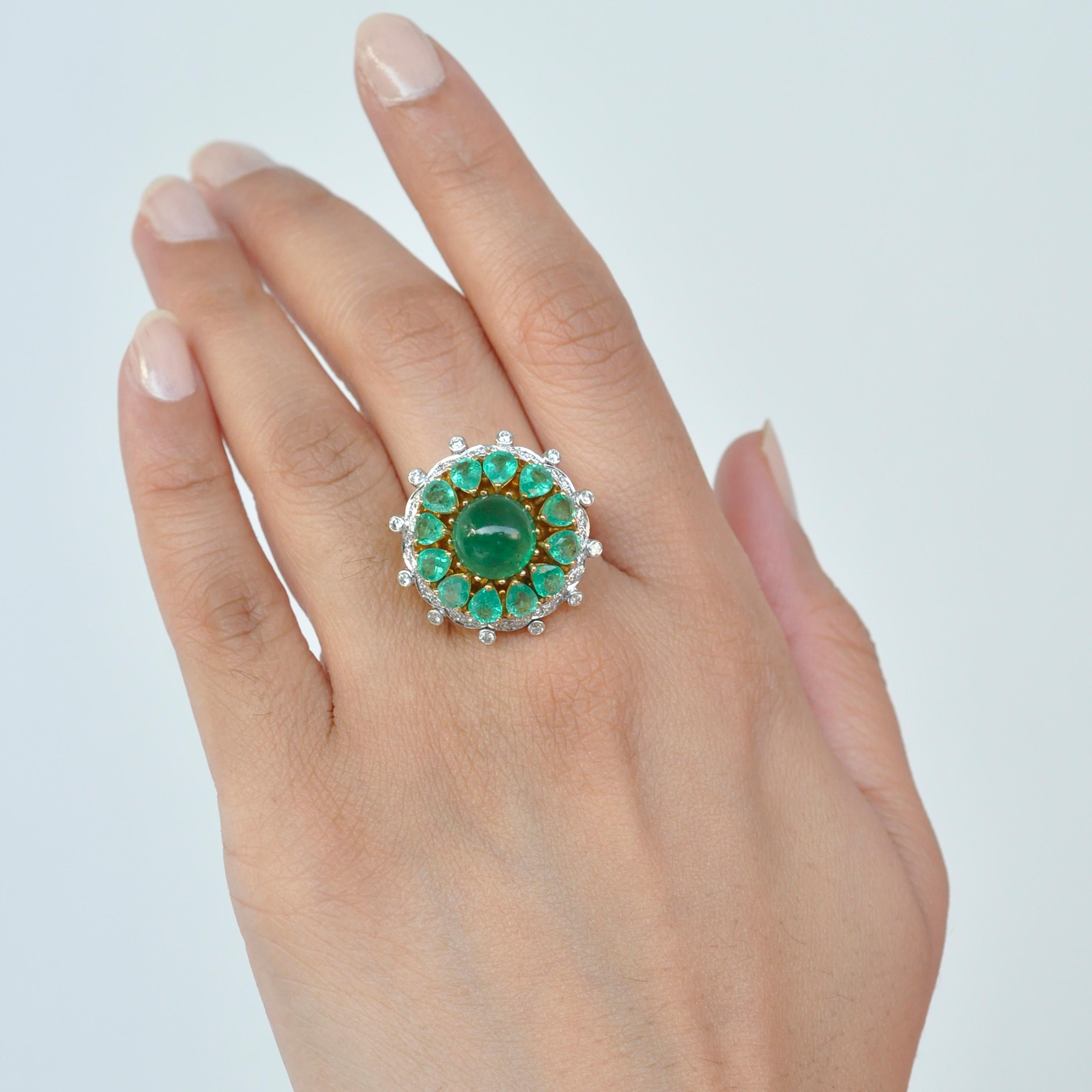 18 karat yellow gold zambian emerald cabochon diamond dome cocktail ring.

Made with the finest of metal alloys, this stamped 18 karat gold zambian emerald diamond dome cocktail ring is indeed a statement ring. Pear shaped lustrous emerald surround