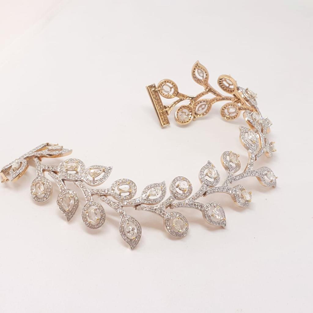 This cuff bracelet is a reflection of movement. Each link is flexible & the bracelet wraps itself on the wrist very comfortably.Fancy shape brilliant cut & rose cut diamonds are centered around a line of finely pave set brilliant cut diamonds