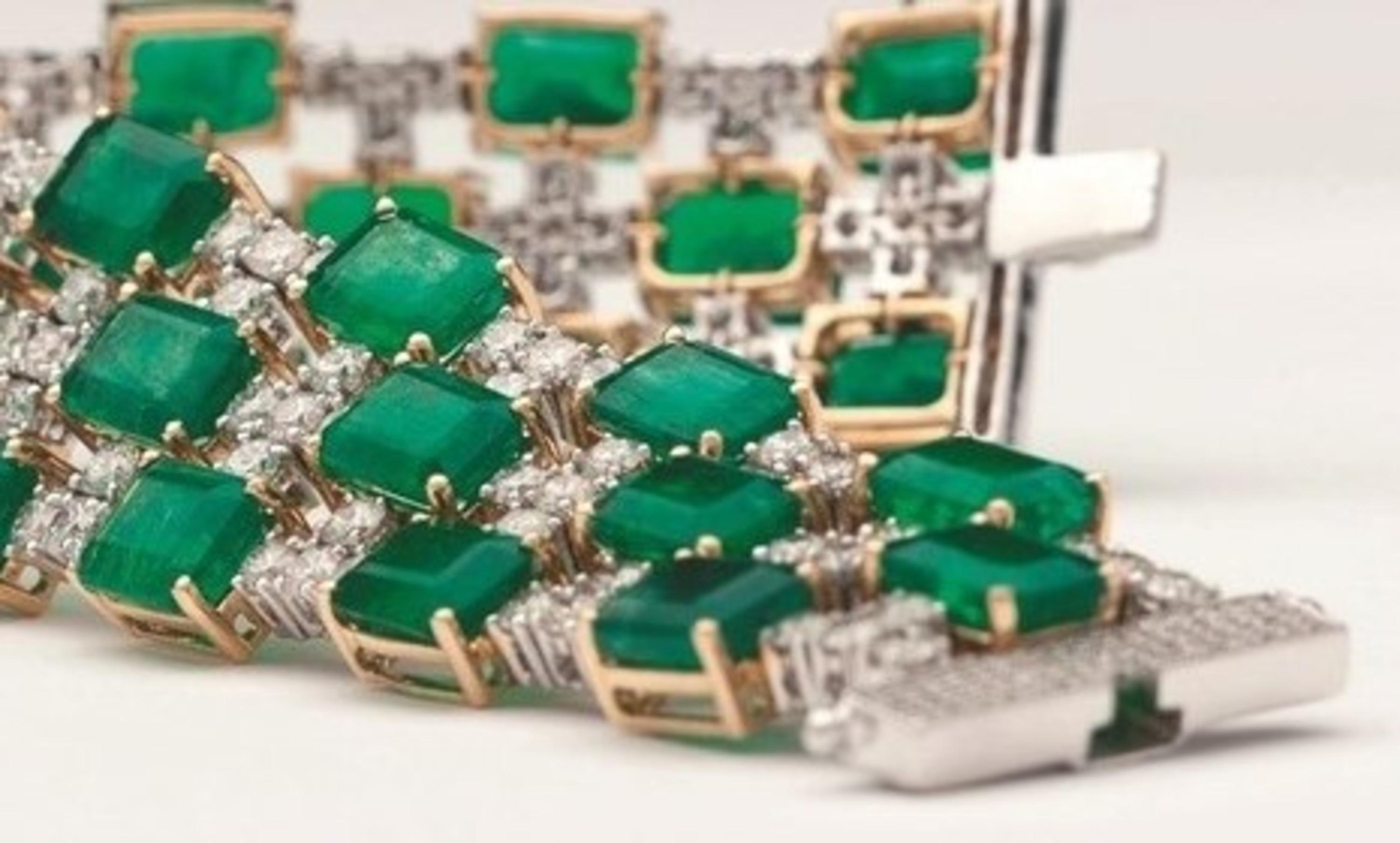 This 18 karat yellow gold rhodium plated lace bracelet stands out on the basis of an exceptional suite of calibrated Zambian emeralds with brilliant cut diamonds.Octagonal emerald cut emeralds and brilliant cut round diamonds seem a harmonious blend