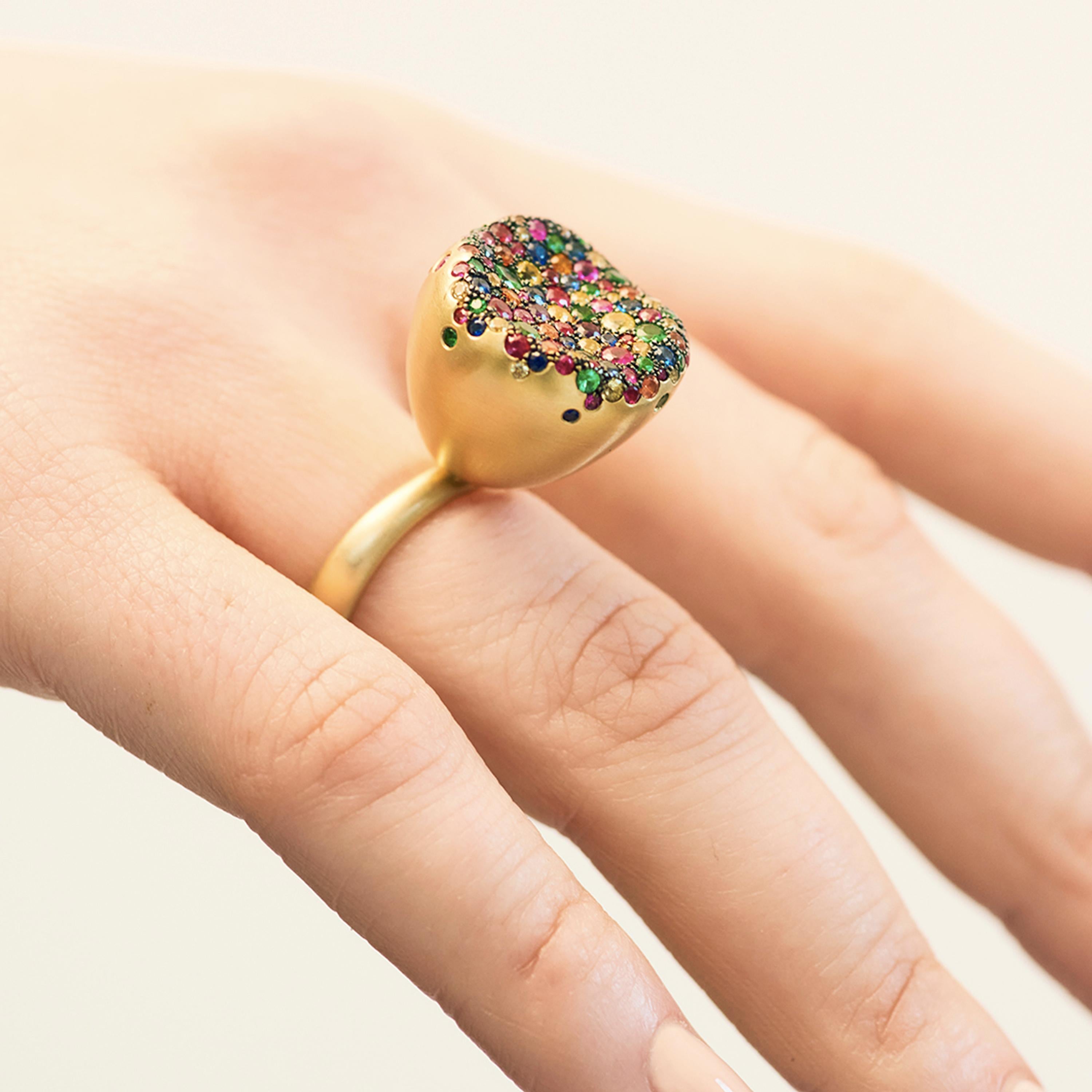 Nada Ghazal’s Baby Malak Flourish Bonbon Big Ring is soft in its form and finish. Subtly referencing a marquise cut in its shape, the brushed finish applied to the surface of the gold compliments the organic form of the ring. Coloured sapphires,