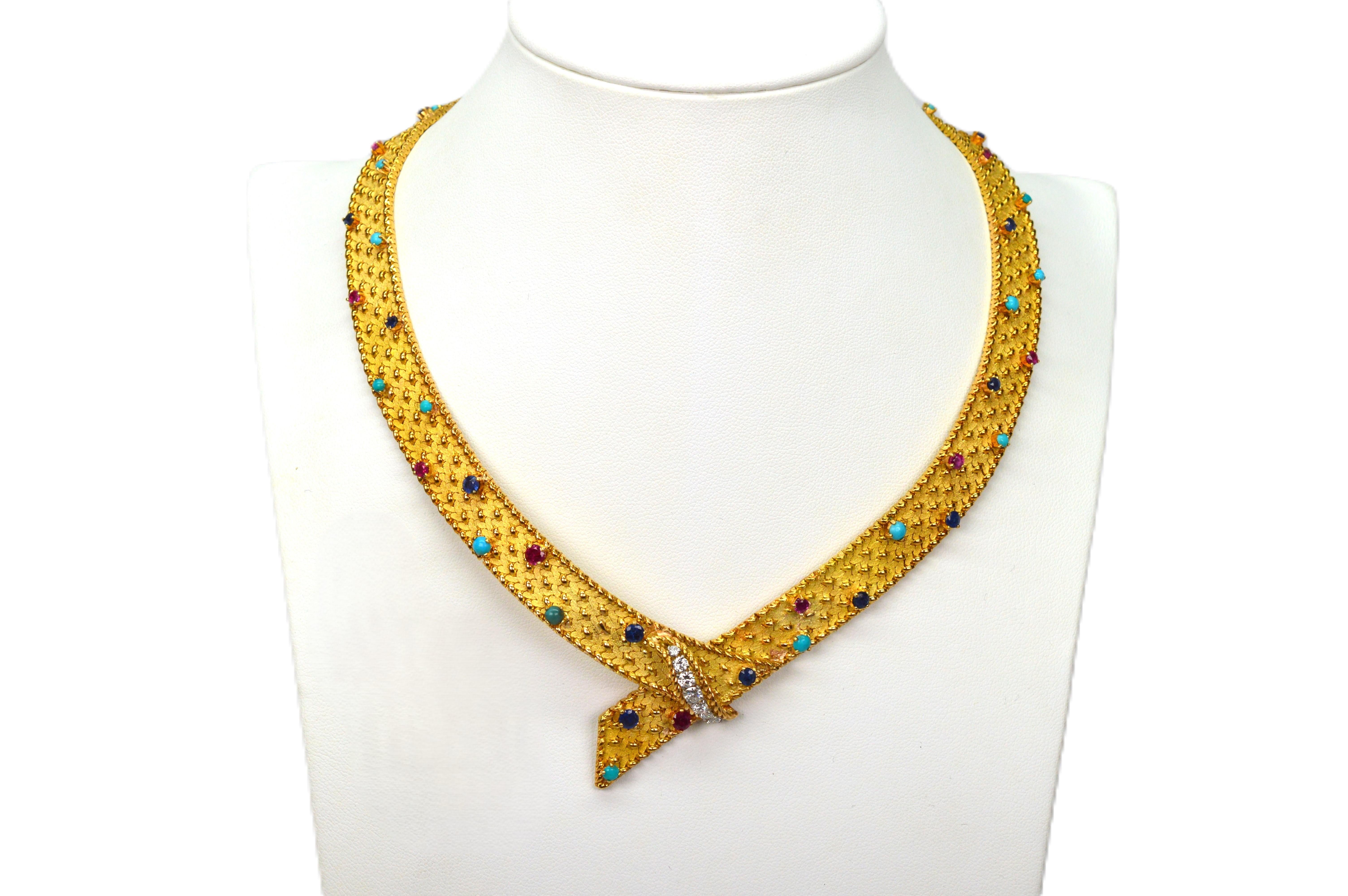 White diamonds, red rubies, blue sapphires and turquoise bejewel the length of this gorgeous contemporary choker style necklace meticulously crafted in 18 karat yellow gold. Fine goldsmithing using a bright gold half loop weave and braid trim