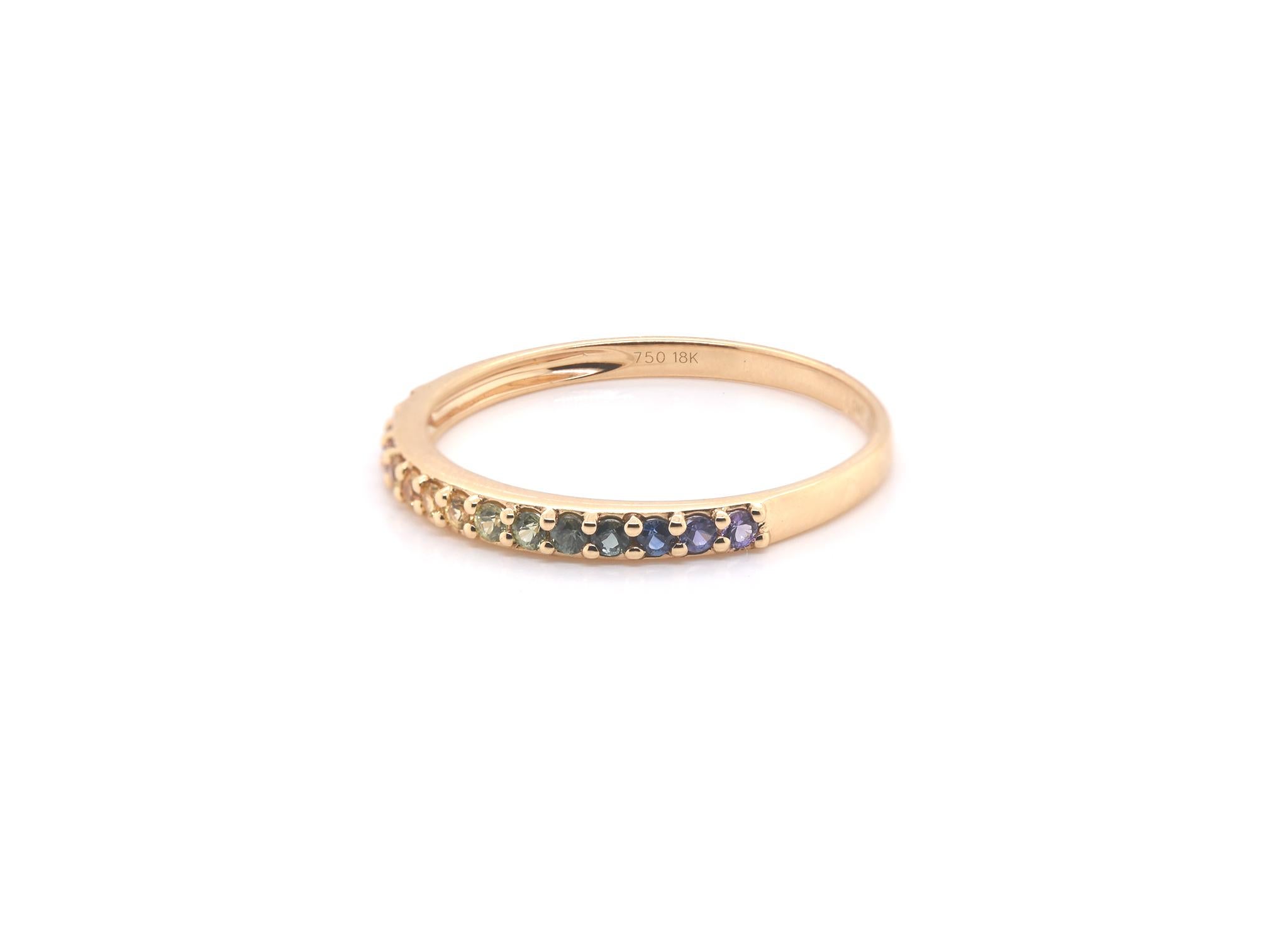 Material: 18k yellow gold
Rainbow Sapphires: 15 Round cut = .28 cttw 
Ring Size: 8 (allow up to two additional business days for sizing requests)
Weight: 1.63 grams
