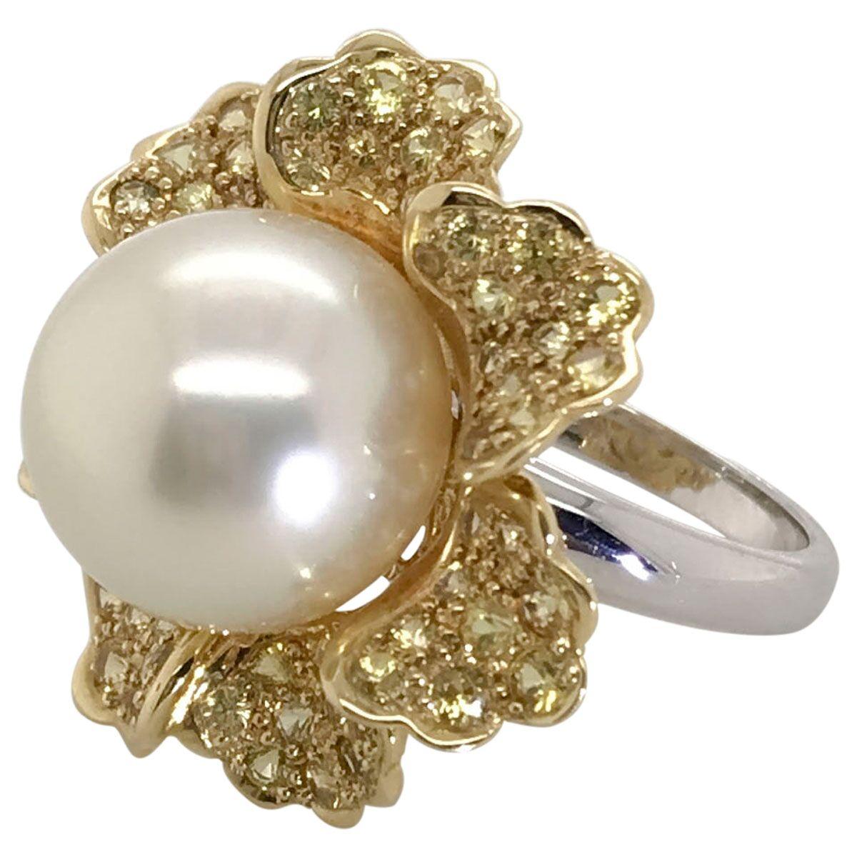 Direct from the pristine waters off Western Australia, this amazing South Sea Pearl ring is a standout. Looking radiant on the finger like a big sunflower with glistening yellow sapphires mounted in 18k yellow gold. At the centre is a magnificent