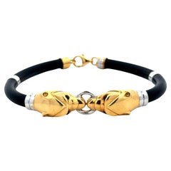 Bracelet en or jaune et blanc 18 carats avec panthère à double tête et cordon en caoutchouc noir