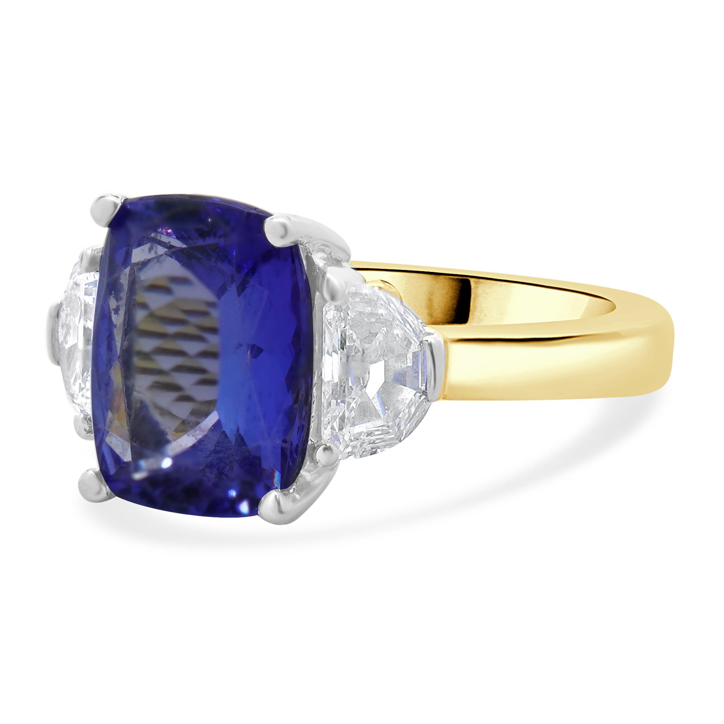 Designer: custom design
Material: 18K yellow & white gold
Diamond: 2 half moon cut = 2.00cttw
Color: H
Clarity: SI1-2
Tanzanite: 1 cushion cut = 4.04ct
Dimensions: ring top measures 11mm wide
Ring Size: 4.5 with sizing beads (please allow two extra