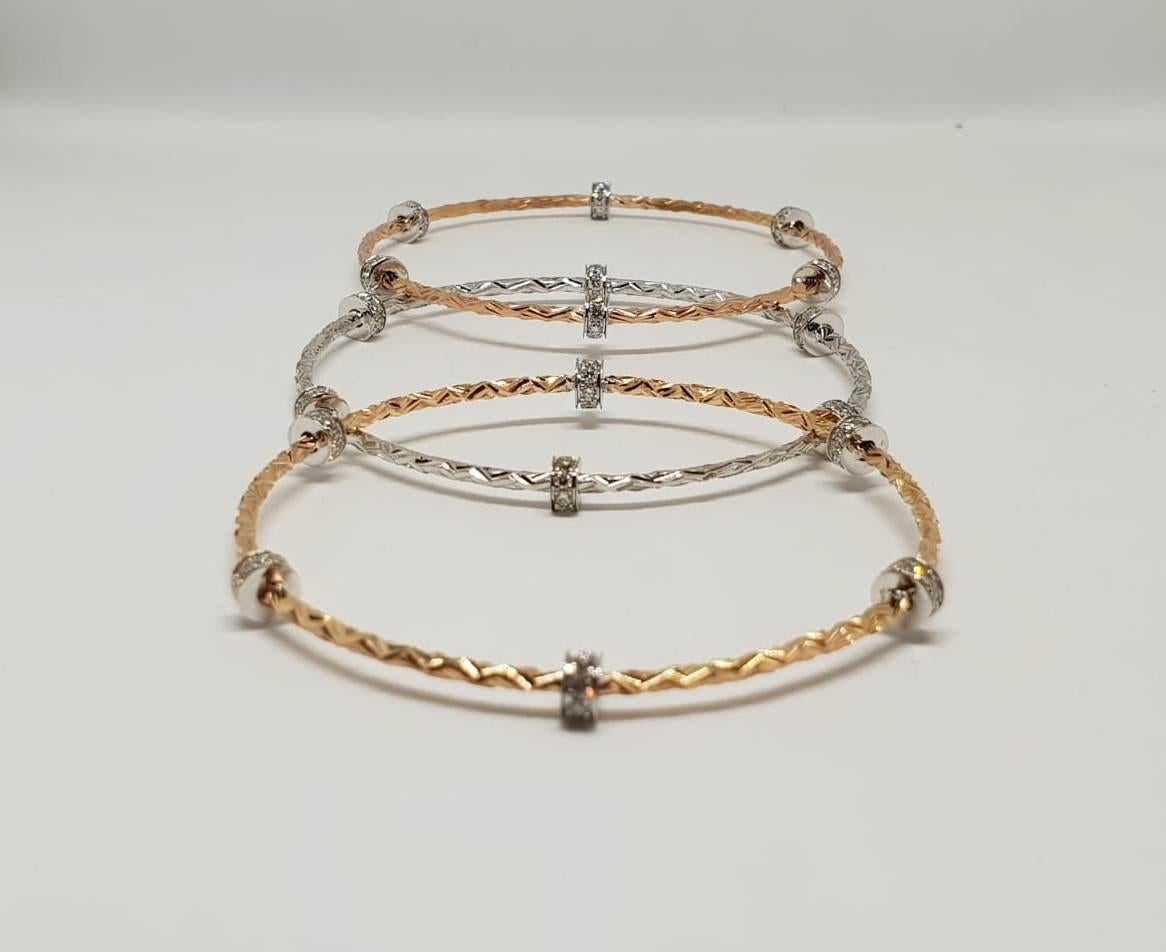 These everyday wear tri colour stackable slip on bangles can be worn together or separately. The hand texture on the metal adds character & the diamond studded rings add a little sparkle.Triology has always intrigued us and these stackable slip on