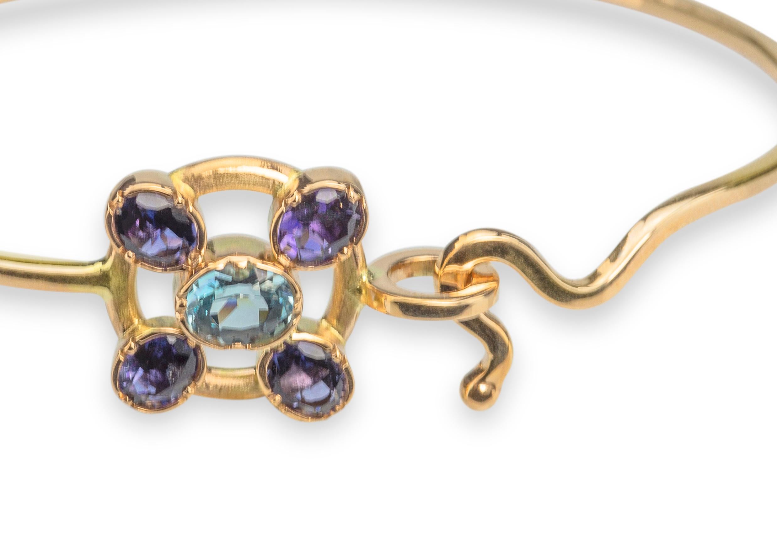 Introducing the exquisite Rossella Ugolini Design Collection, presenting a true masterpiece of jewelry craftsmanship - the handcrafted and hammered 18 Karats Yellow Gold Aquamarine Blue Sapphires Bangle Modern Design Bracelet.  
Crafted with