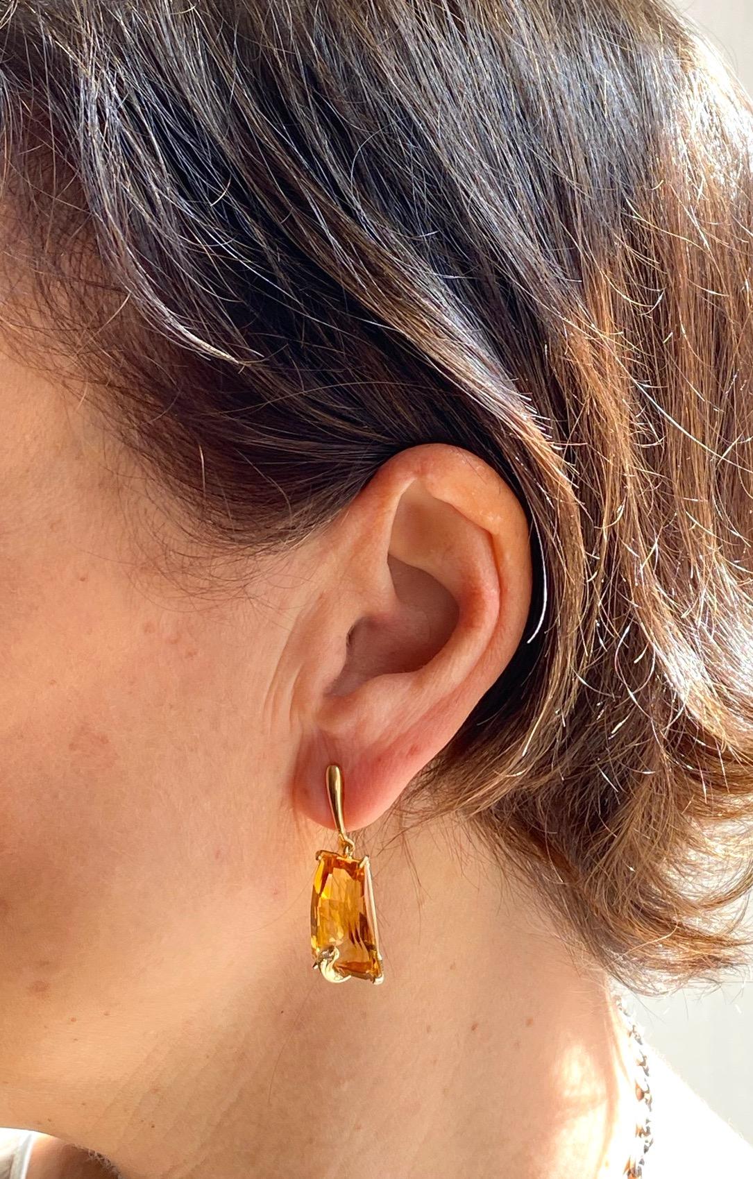 Rossella Ugolini Design Collection this original pair of dangle earrings is handcrafted in 18 karats yellow gold and enriched with two different cut Citrine and 0.04 karats Brown Diamonds brilliant cut. 
The citrine stones have been hand cutted